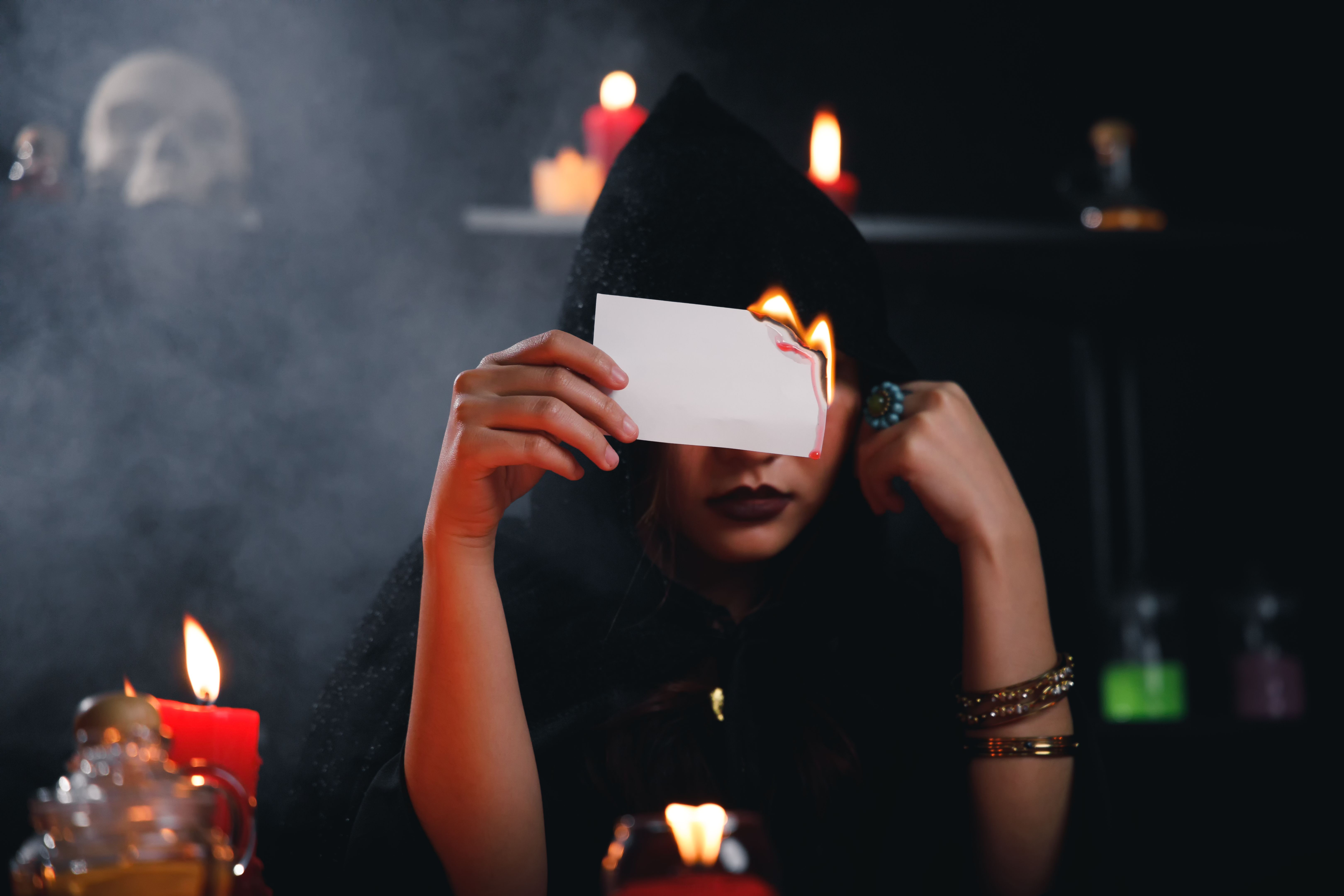Fortune teller holding burn paper.