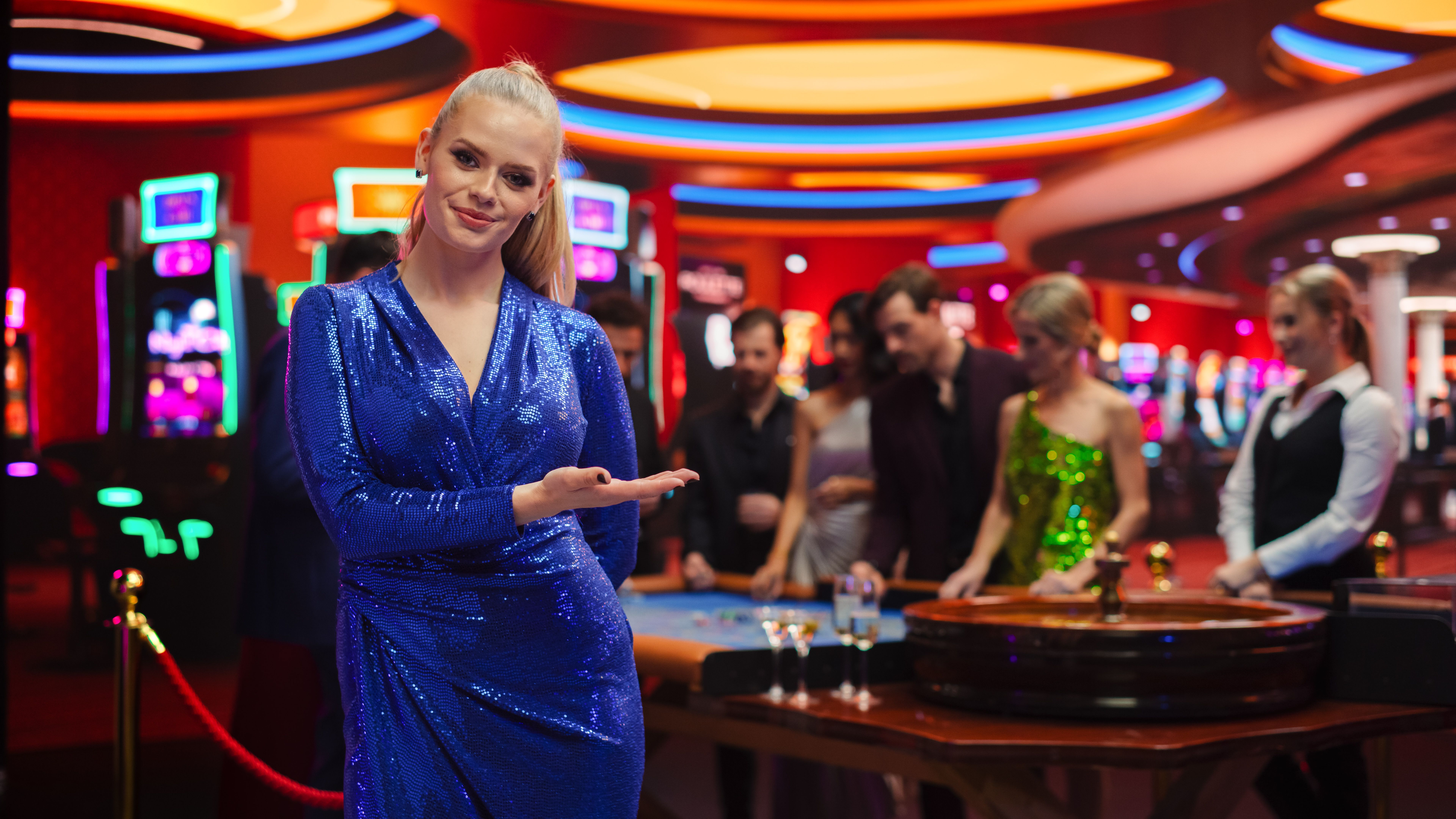 Portrait of a Beautiful Young Caucasian Woman Wearing a Glittering Blue Dress, Standing in a Modeling Pose and Gesturing at an Empty Space for a Company Slogan or Advertising Call to Action Campaign Portrait of a Beautiful Young Caucasian Woman Wearing a Glittering Blue Dress, Standing in a Modeling Pose and Gesturing at an Empty Space for a Company Slogan or Advertising Call to Action Campaign