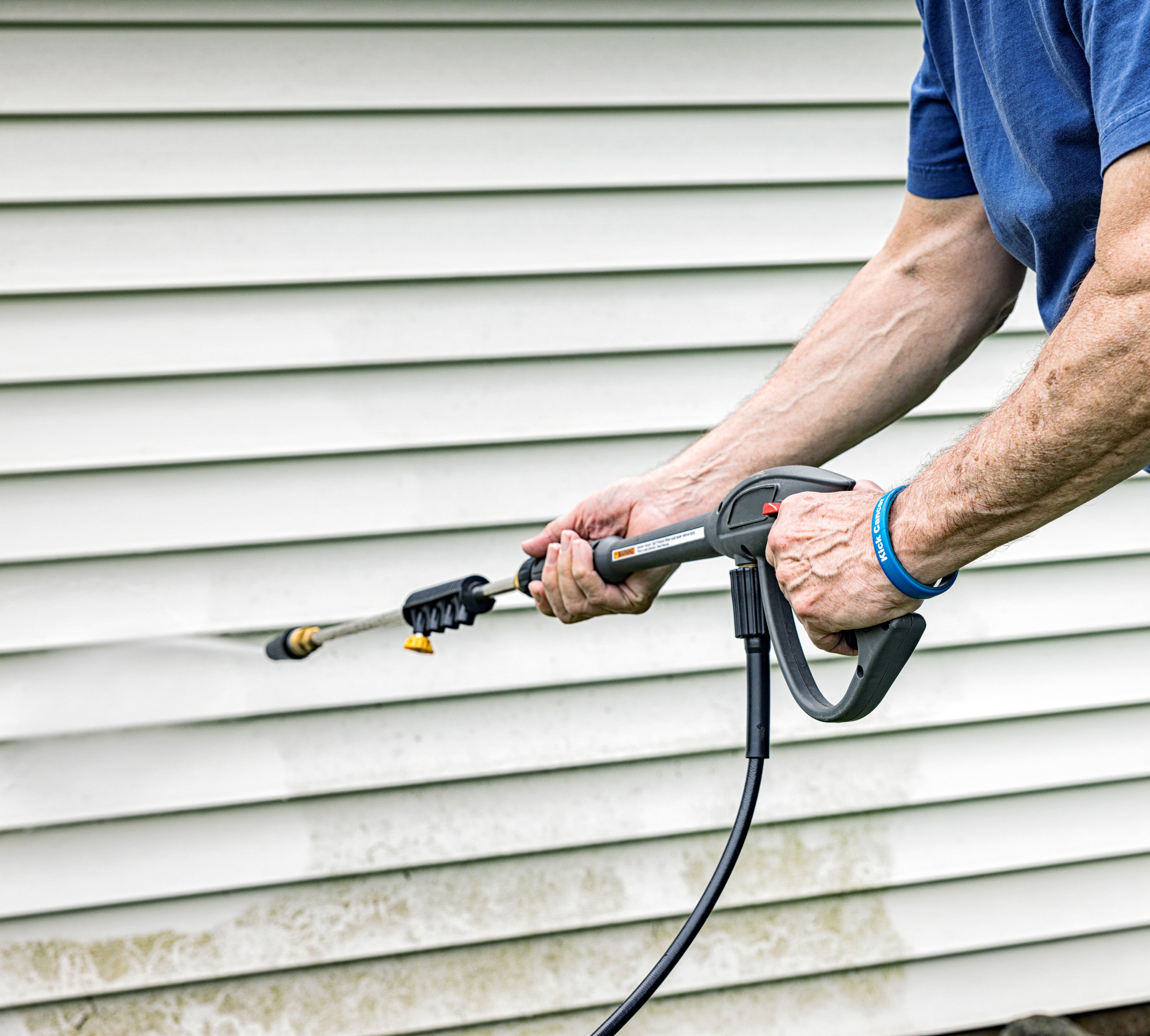 homeowner using pressure washer