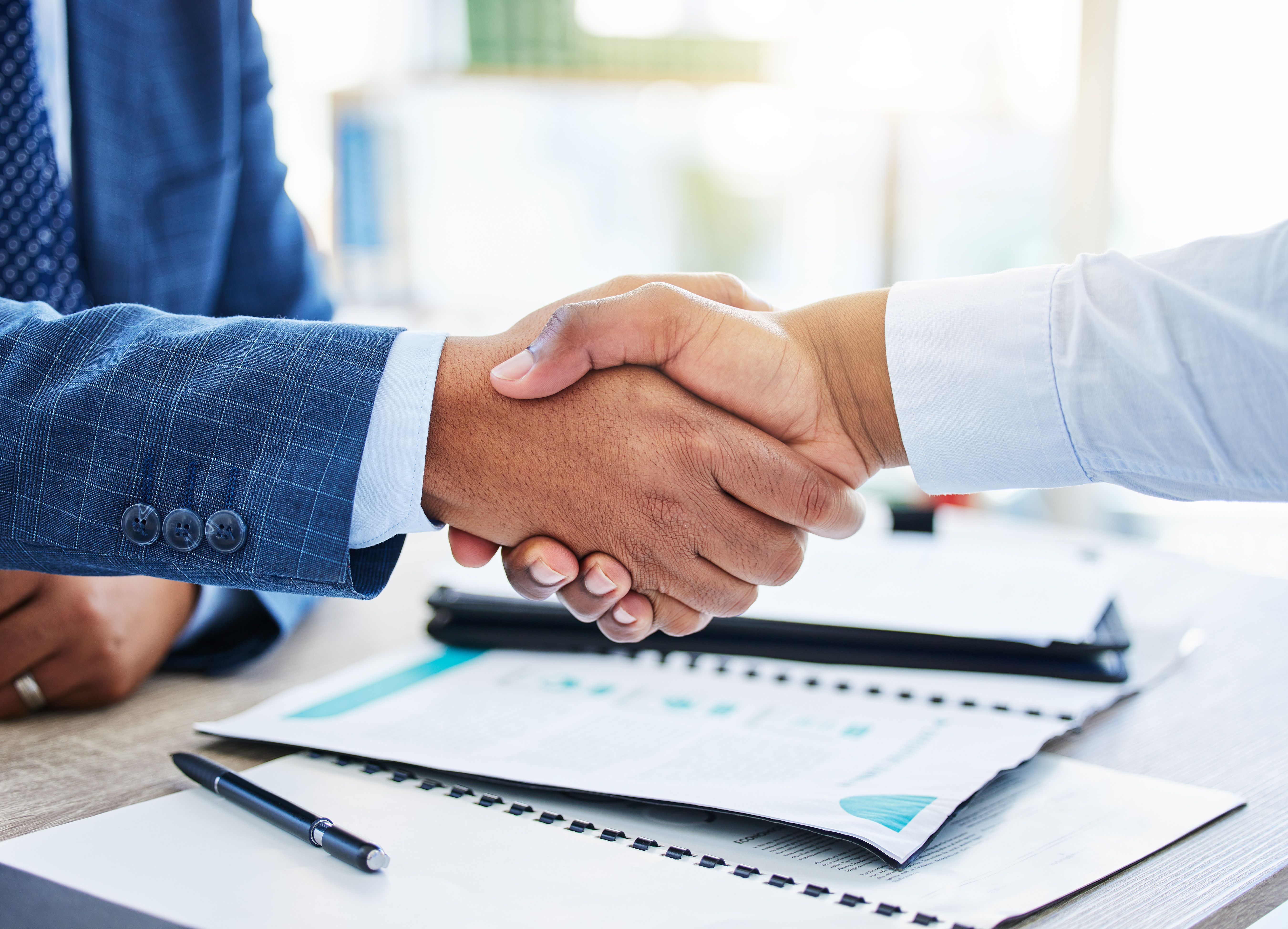 Shot of two unrecognizable businessmen shaking hands in a office Shot of two unrecognizable businessmen shaking hands in a office