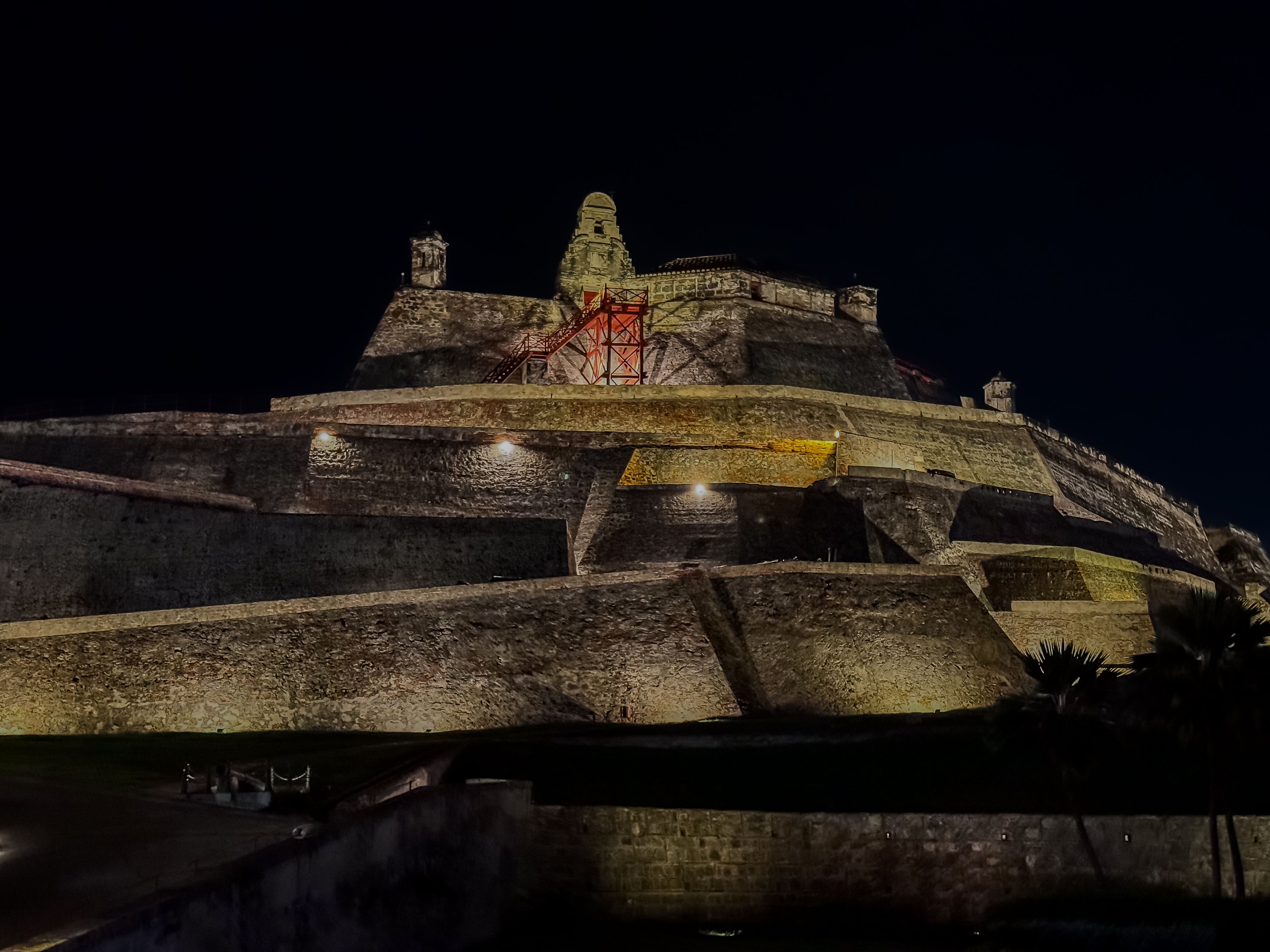 Beautiful aerial drone view of the San Felipe Castle, with the huge Cartagena Flag waving and the city in the the background
