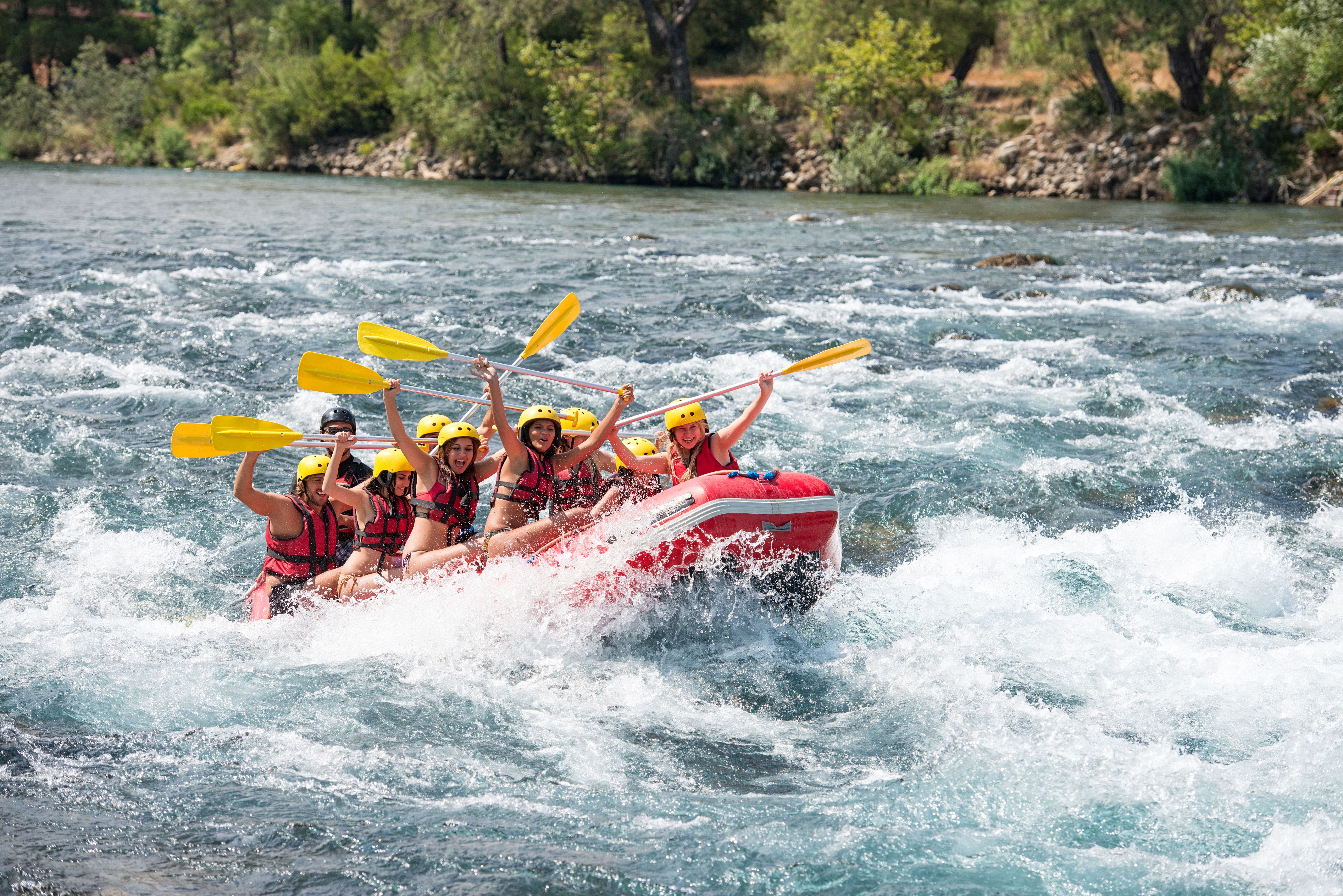 Group of people white water rafting
