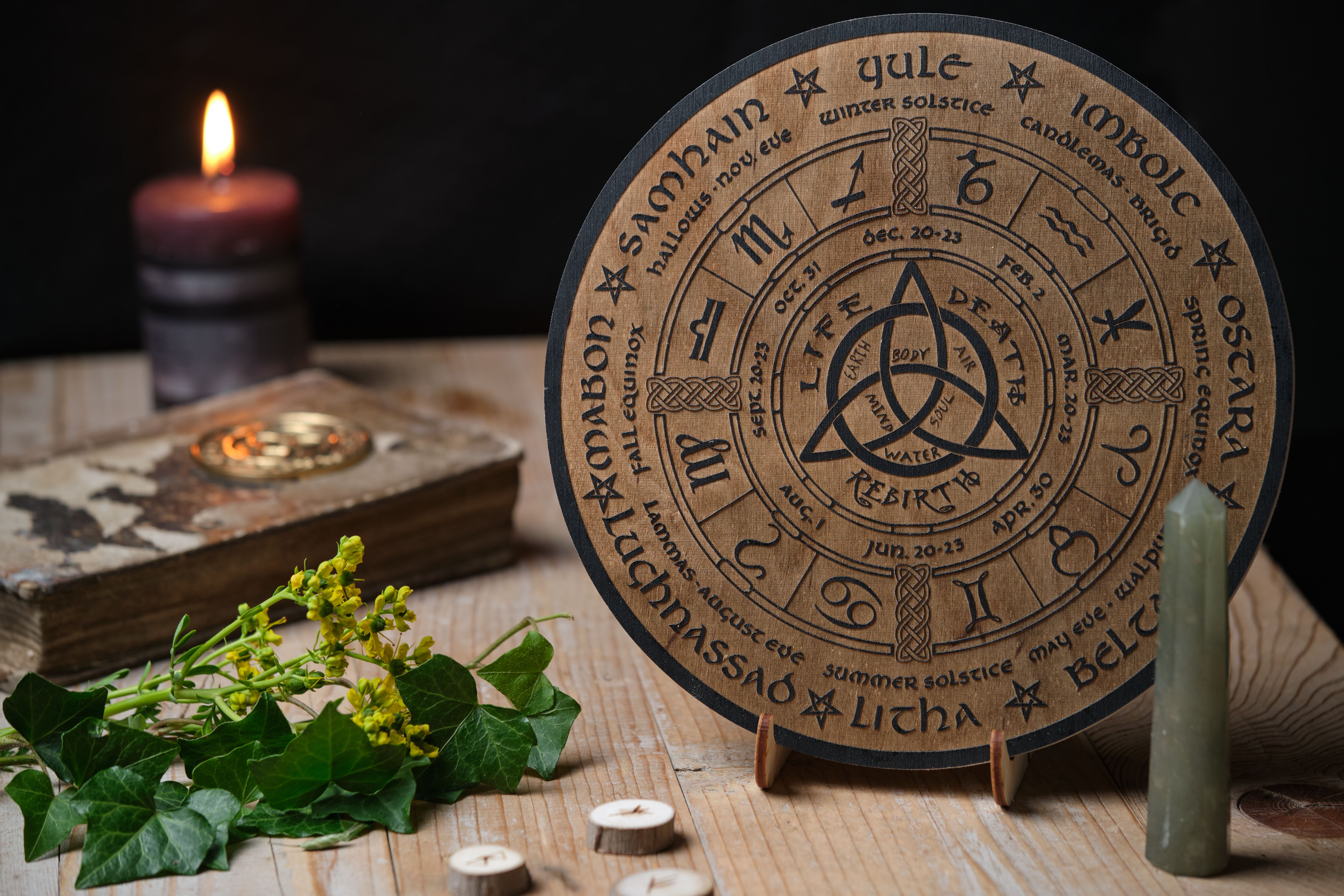 Mystic Wheel of the Year with runes and ritual items on a wooden table. Spiritual and pagan concept.