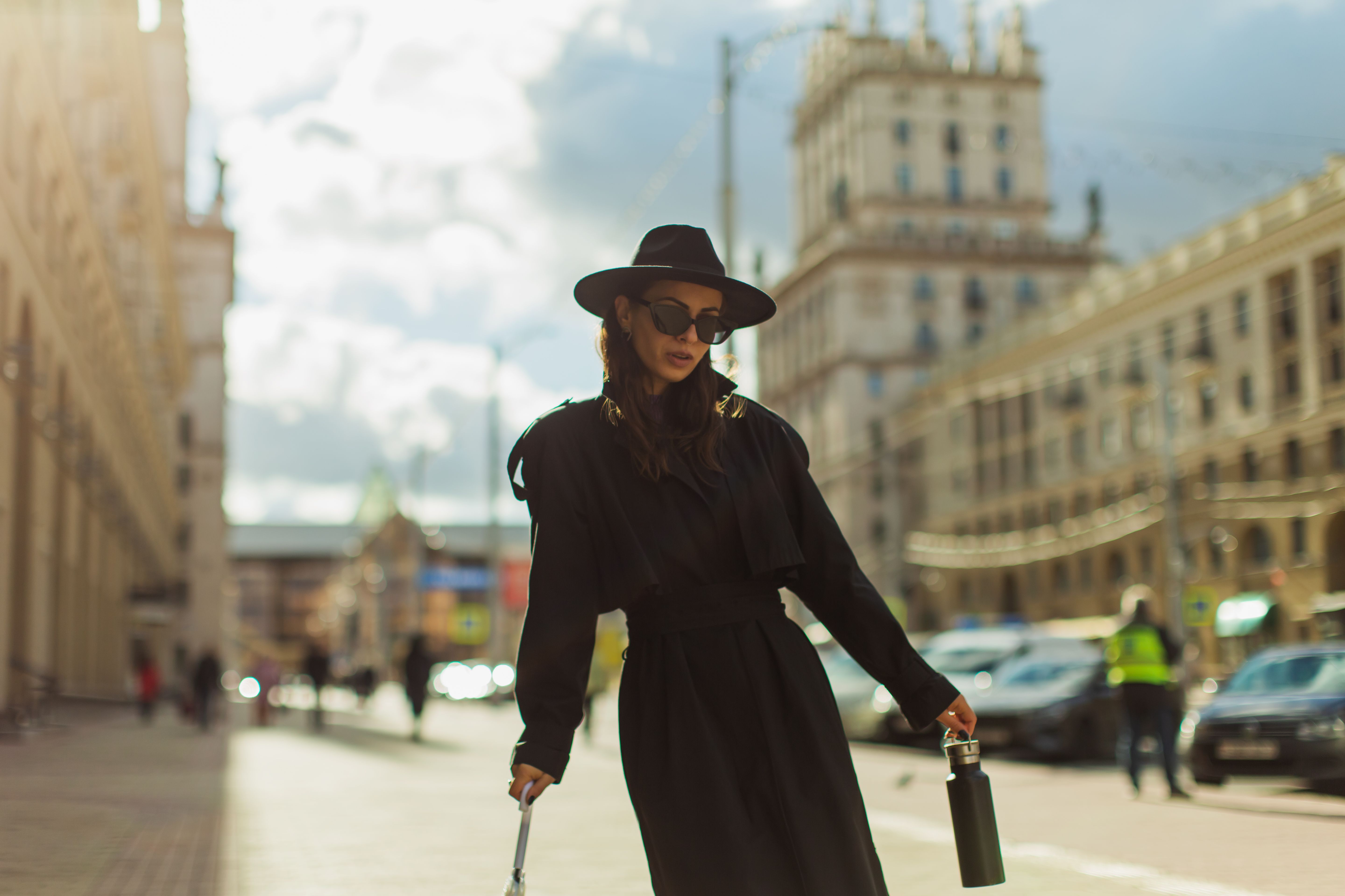 Woman in black coat enjoying a walk in the city. Street style