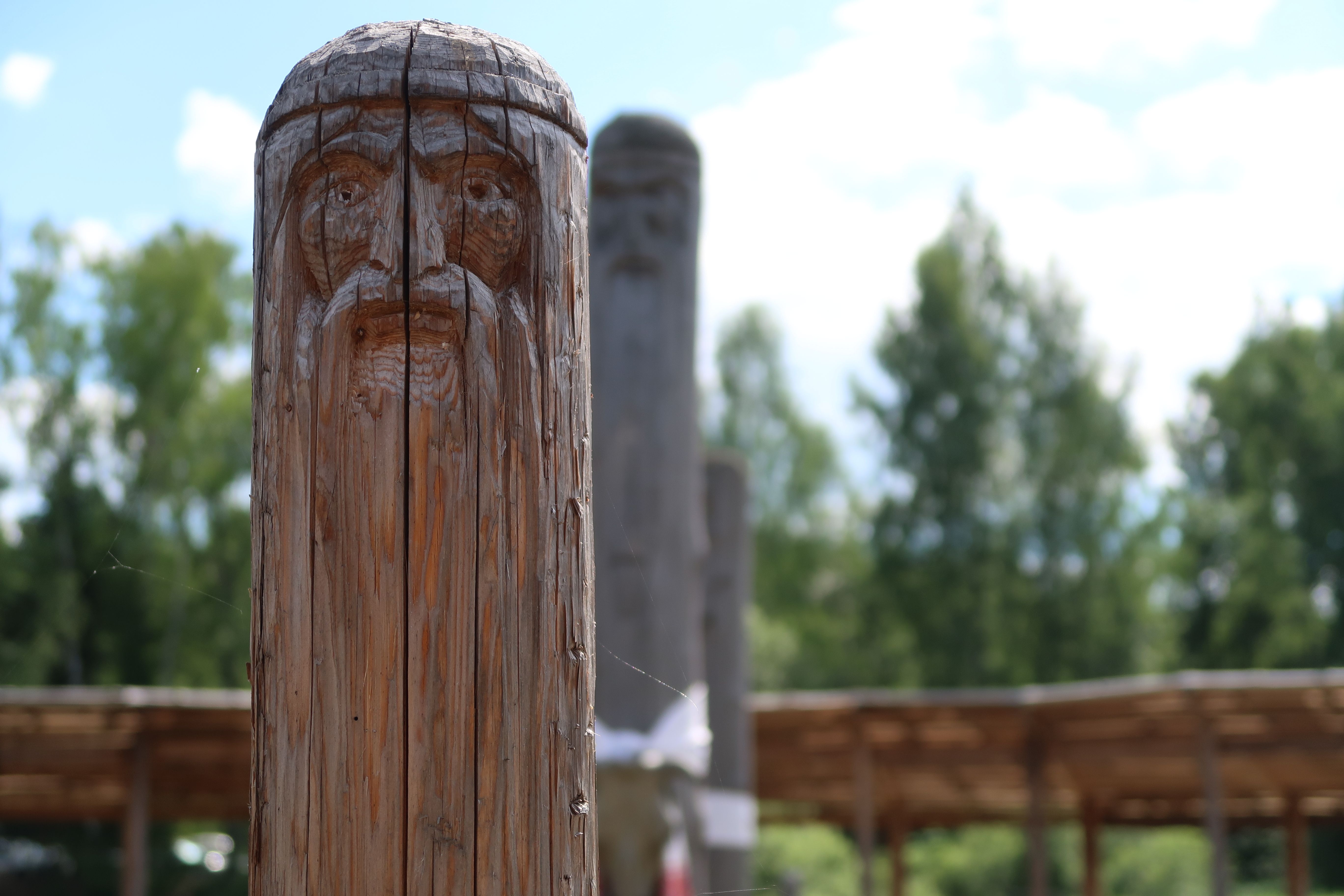 Ancient wooden slavic pagan idol of god. Heathen temple in the forest
