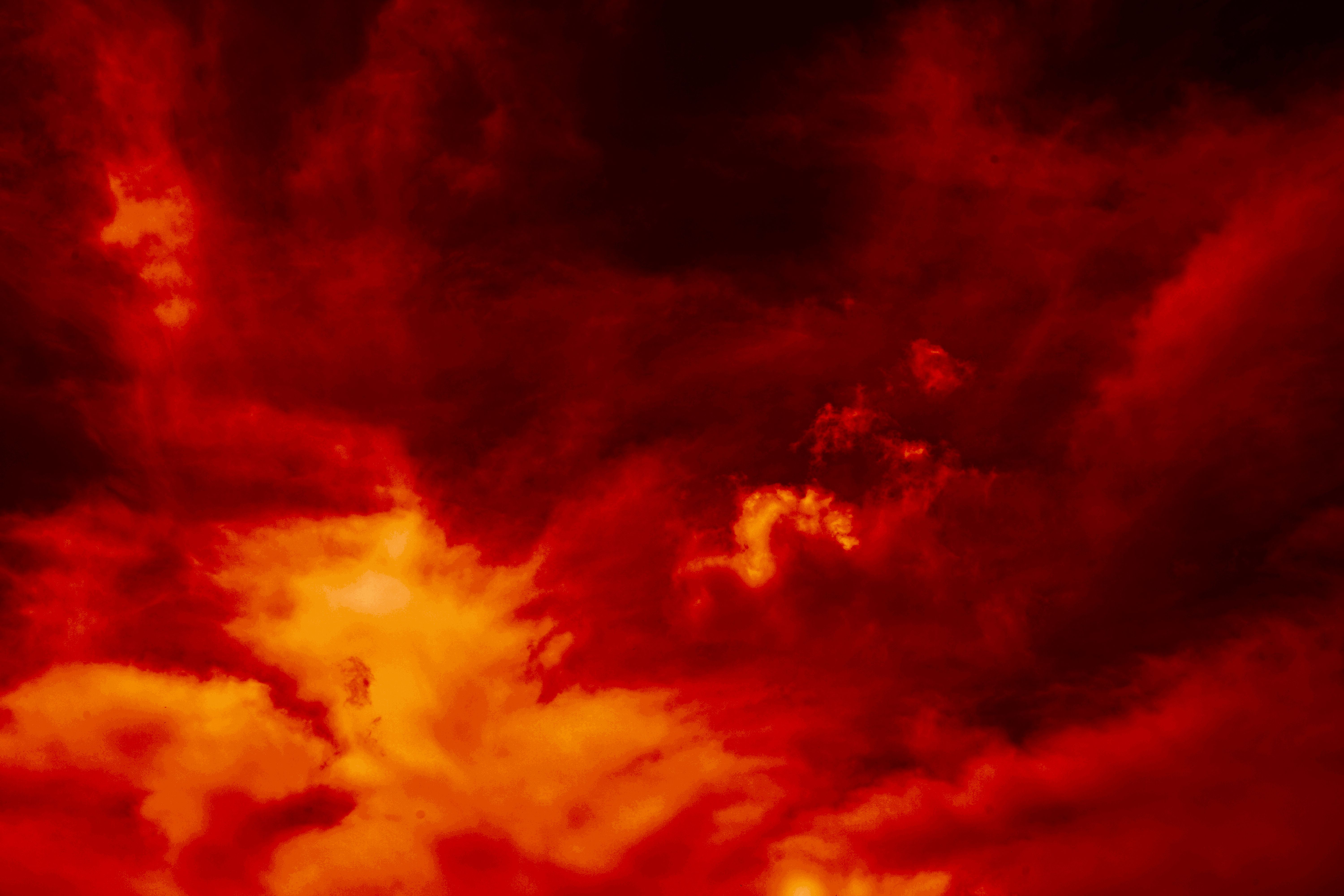 Fiery red dramatic sky. Fire, war, explosion, catastrophe, flame. Horror concept. Web banner. Bloody red background with copy space for design.