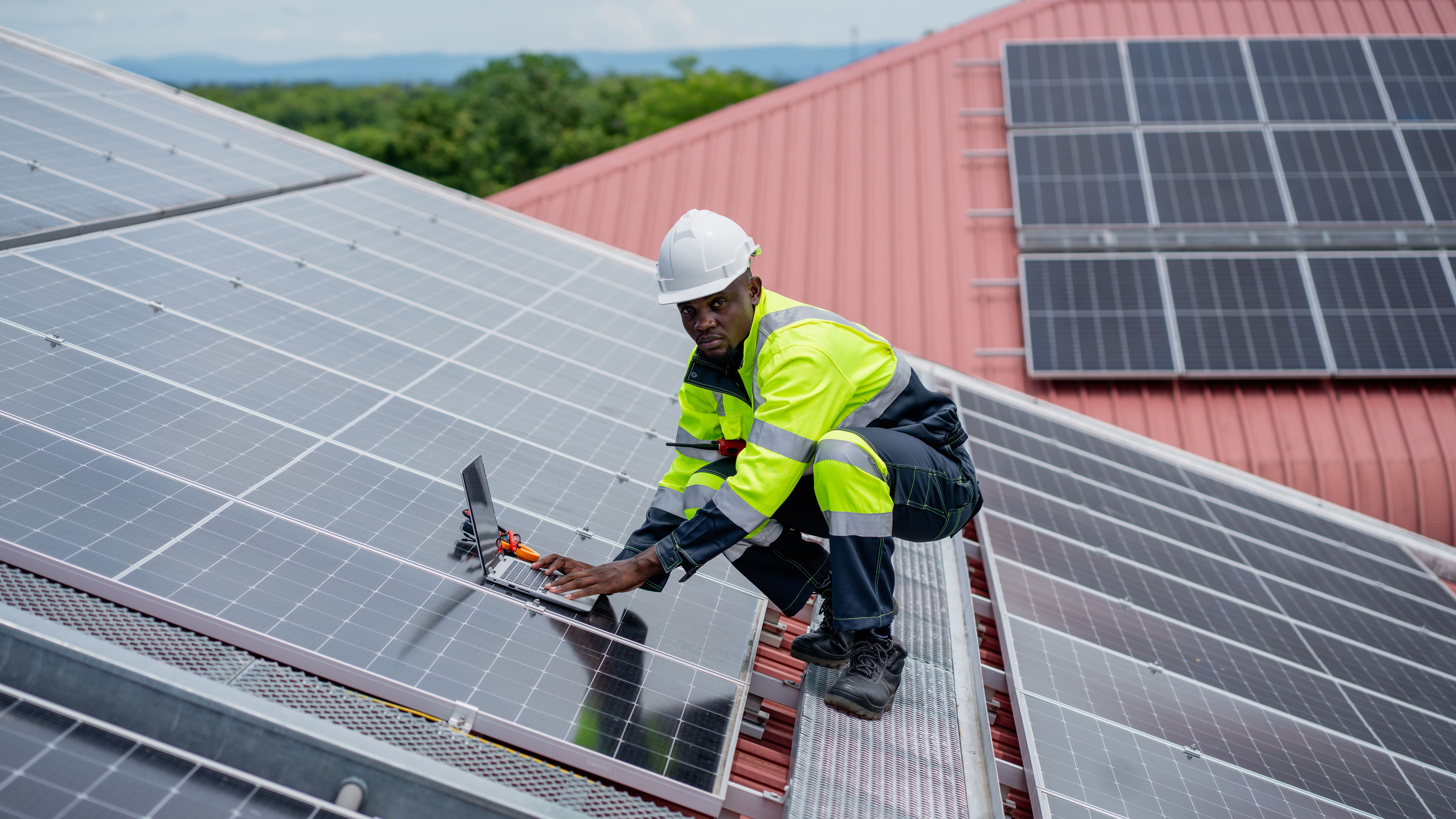 Service engineer checking solar cell on the roof for maintenance if there is a damaged part. Engineer worker install solar panel. Clean energy concept.