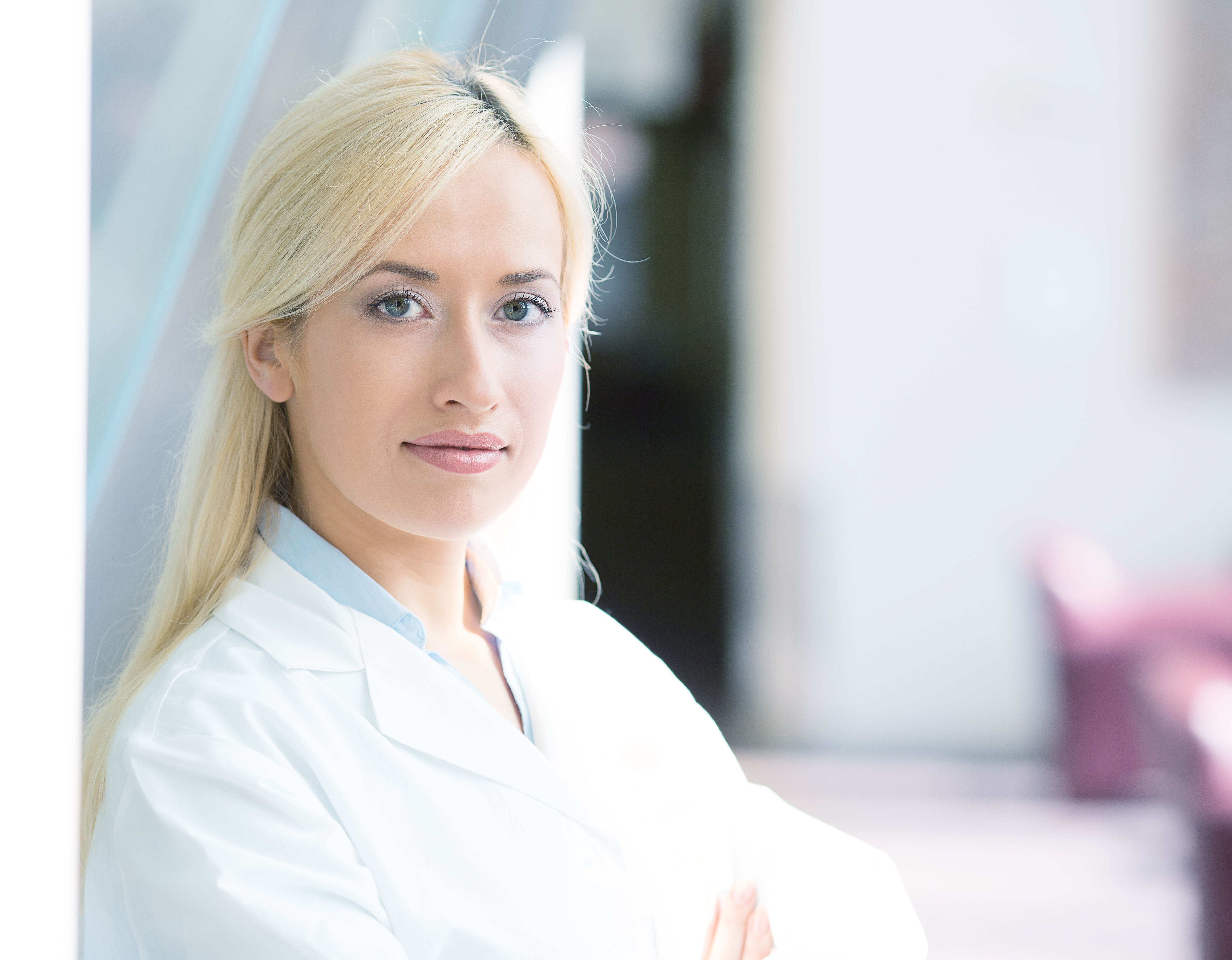young, smiling, confident, female doctor, healthcare professional with stethoscope standing, looking at you young, smiling, confident, female doctor, healthcare professional with stethoscope standing, looking at you