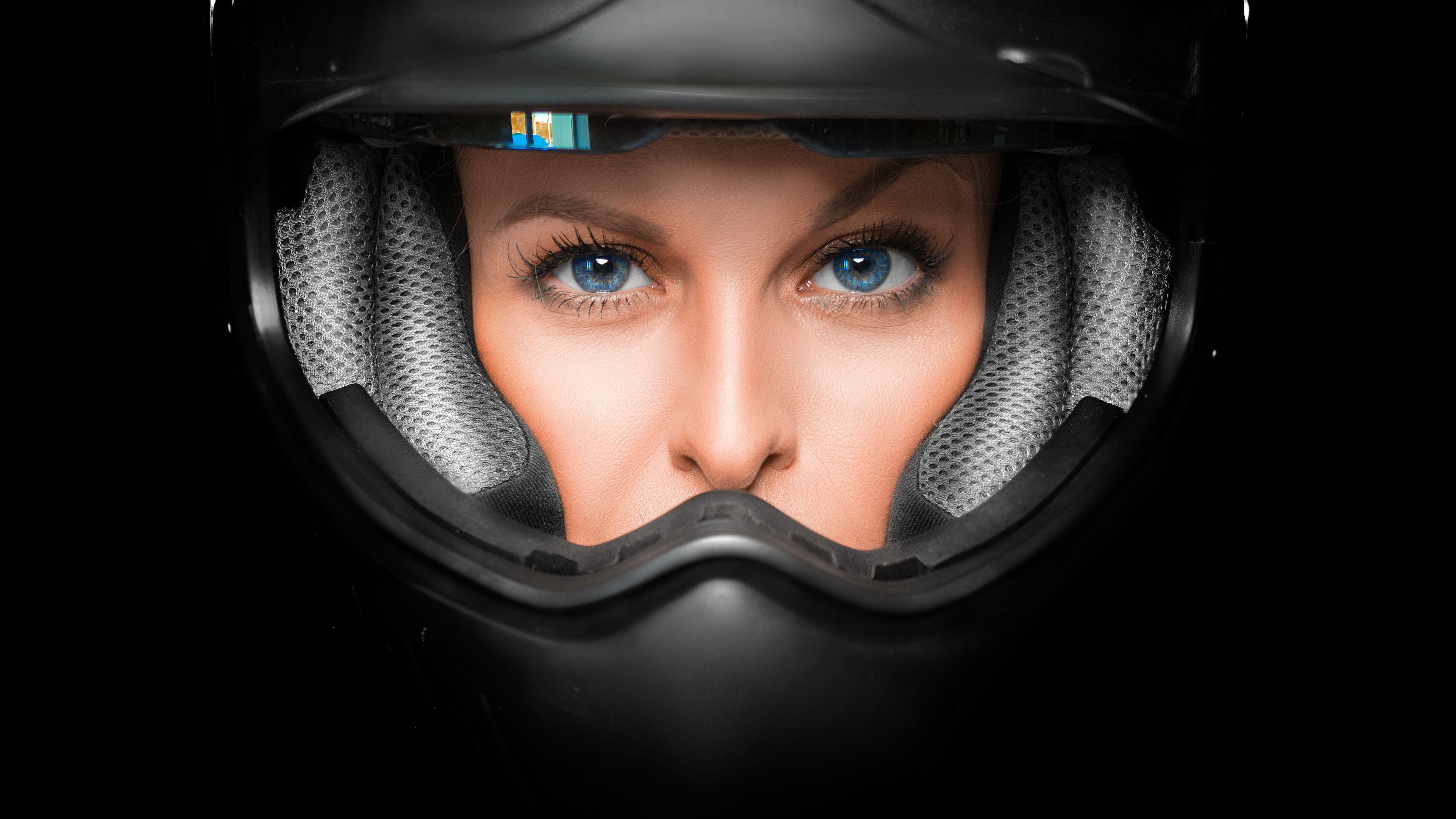 Close up view of a woman face in biker helmet. Close up view of a woman face in biker helmet.