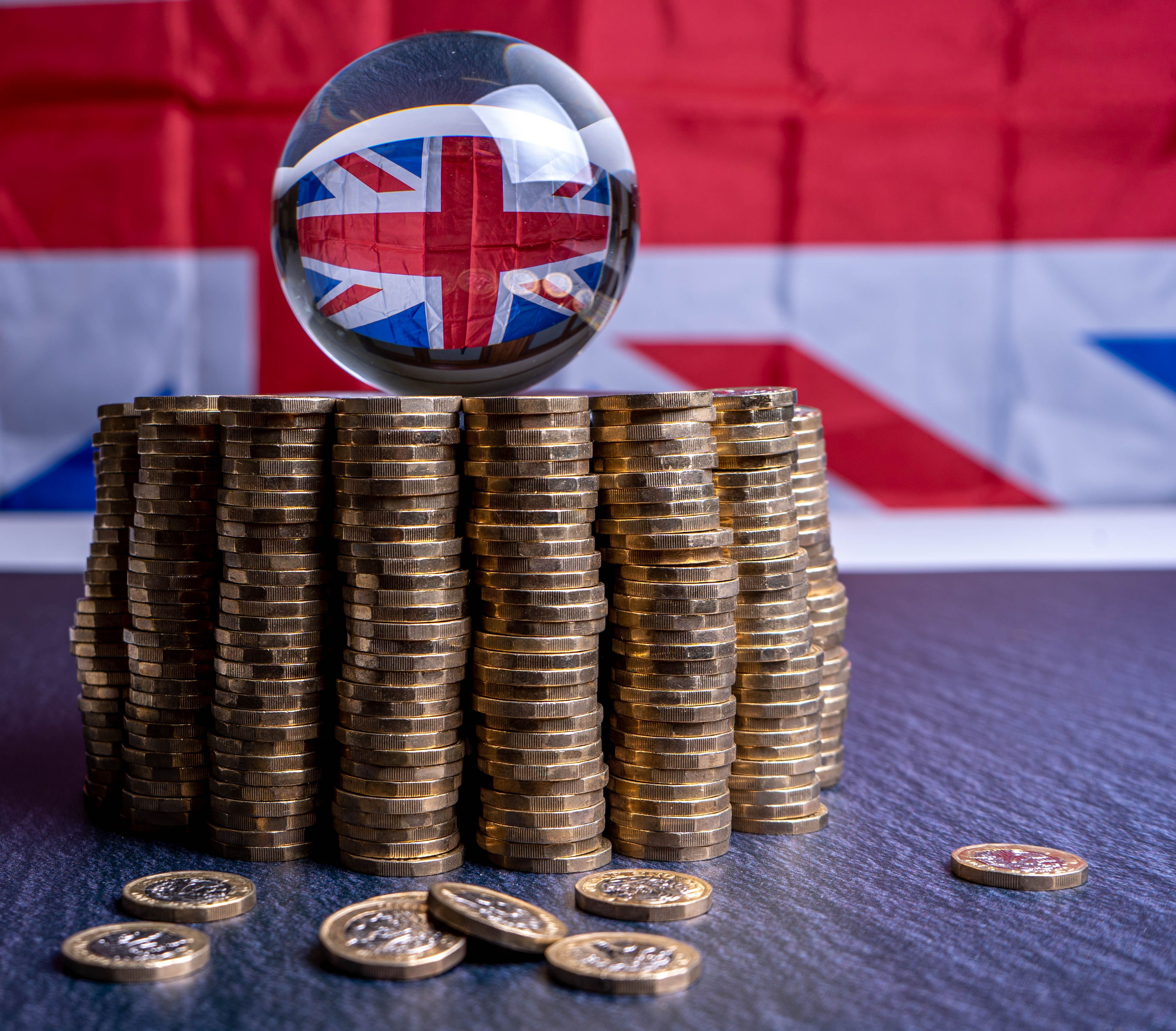 UK pound coins and Union Jack flag