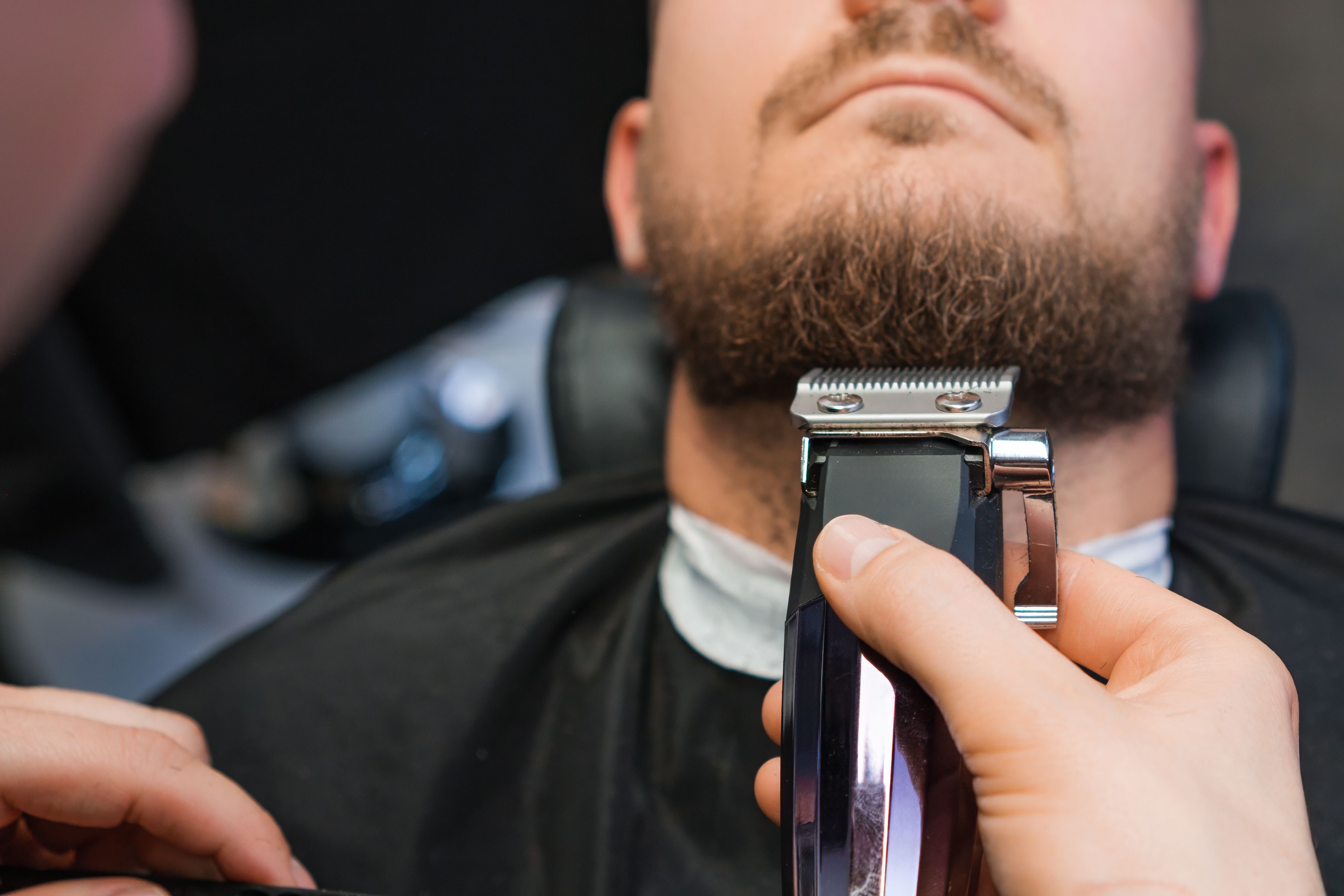 man trimming beard