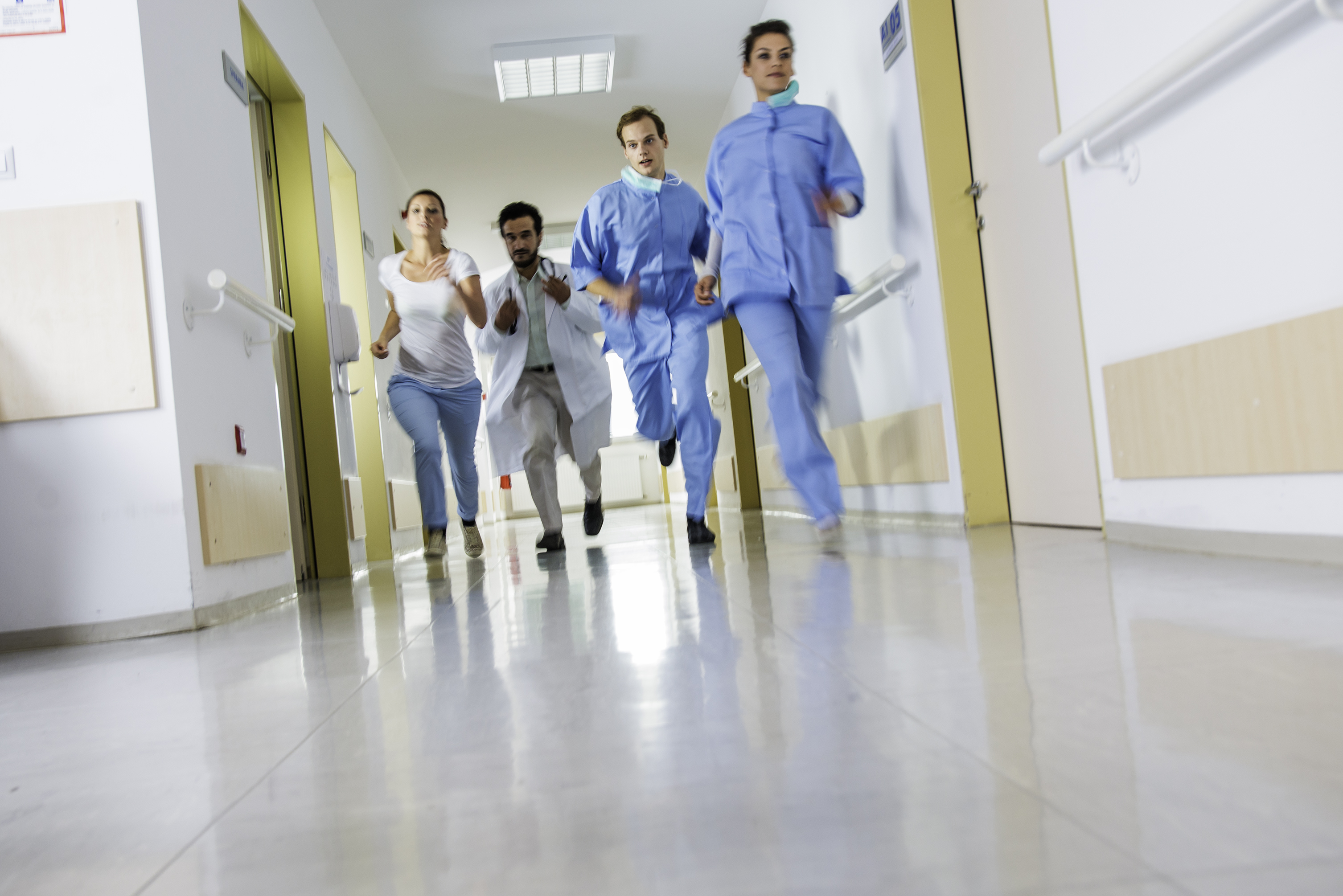 Doctors and nurses rushes for emergency in hospital corridor