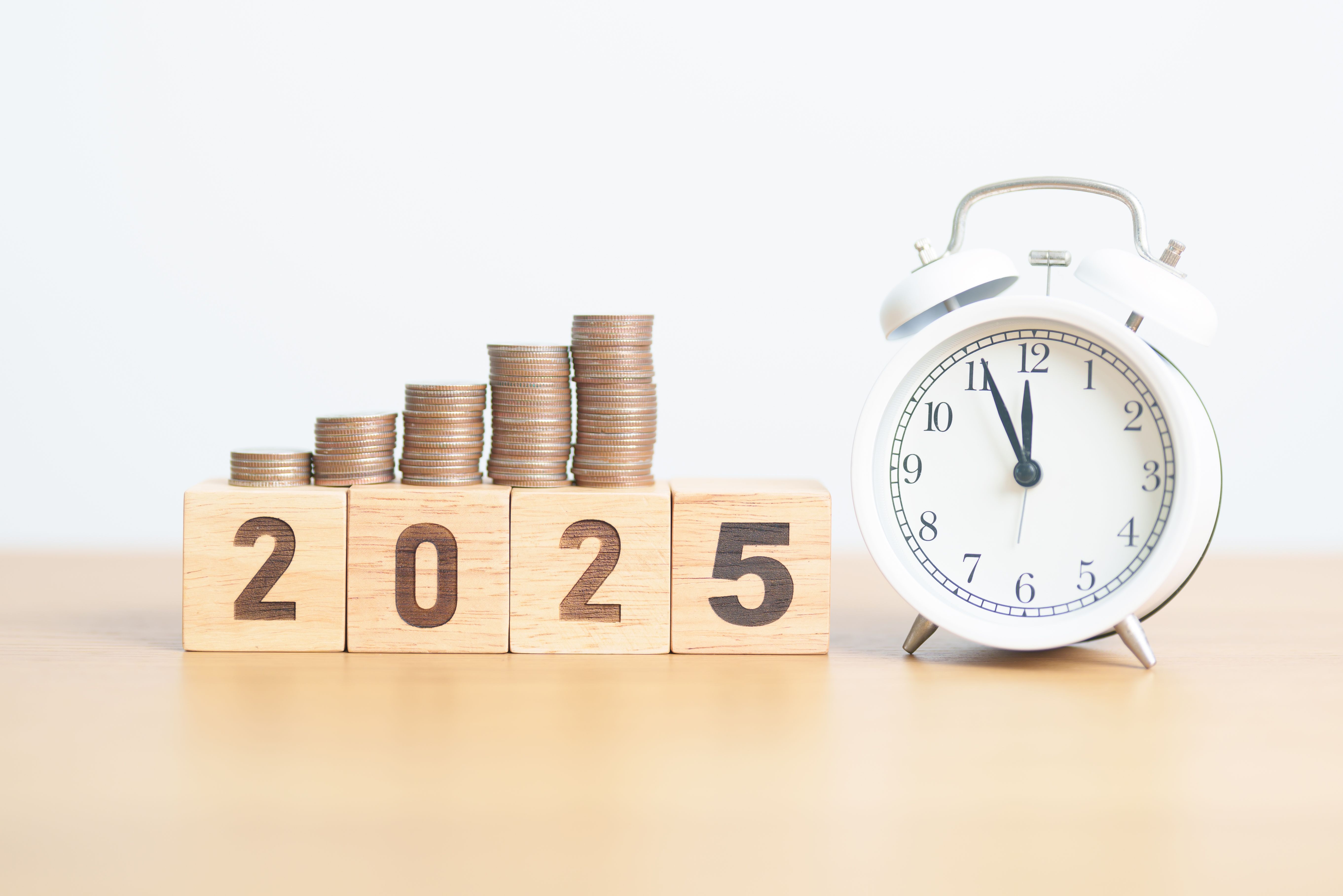 Happy New Year 2025 with clock and coins stack arrangement. Money Saving for Future Plan, Retirement fund, Pension, Investment, Wealth Business, Financial and countdown concepts