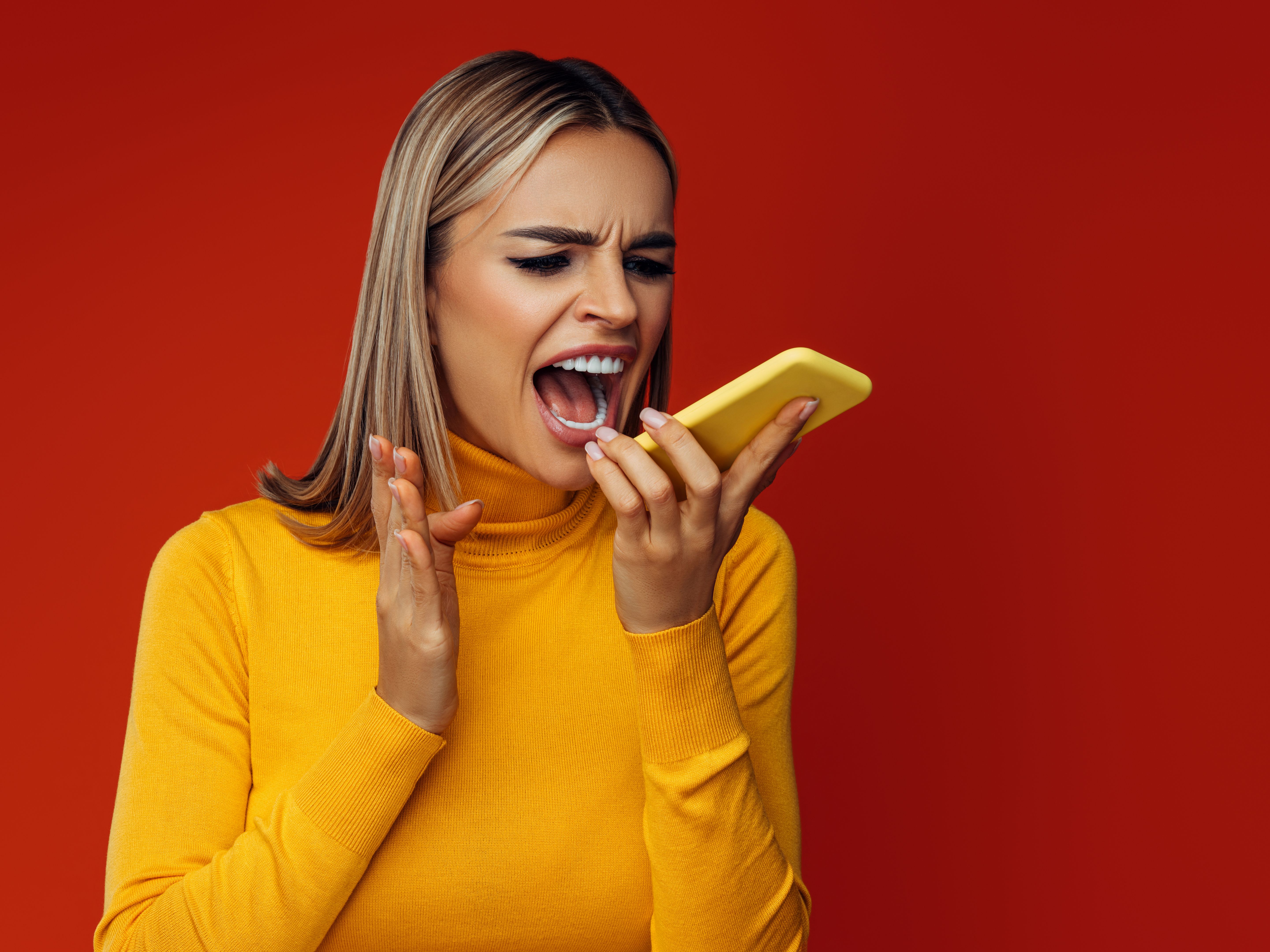 Beautiful emotional woman using smart phone