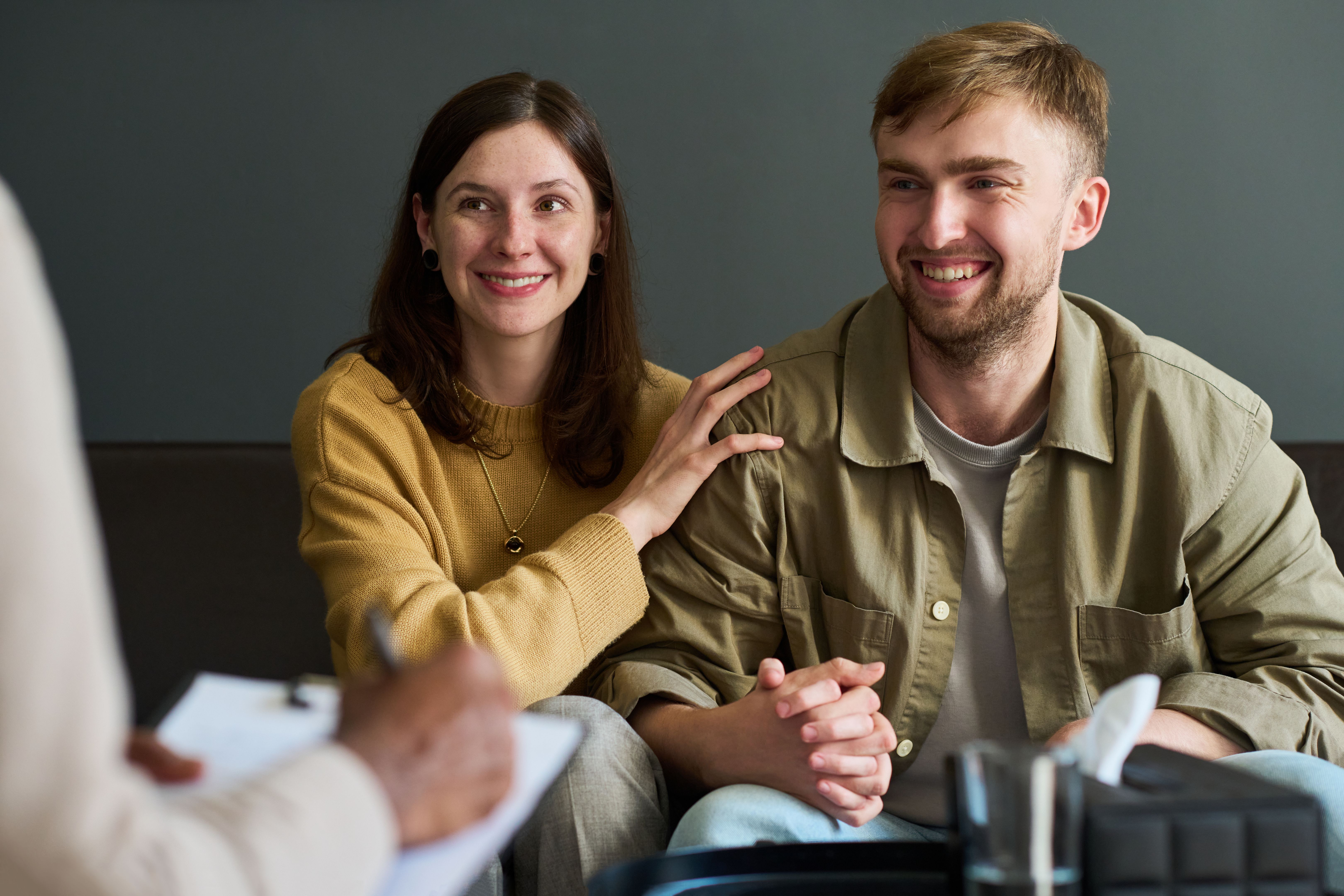 Young Caucasian Couple Smiling While Attending Counseling Session Together
