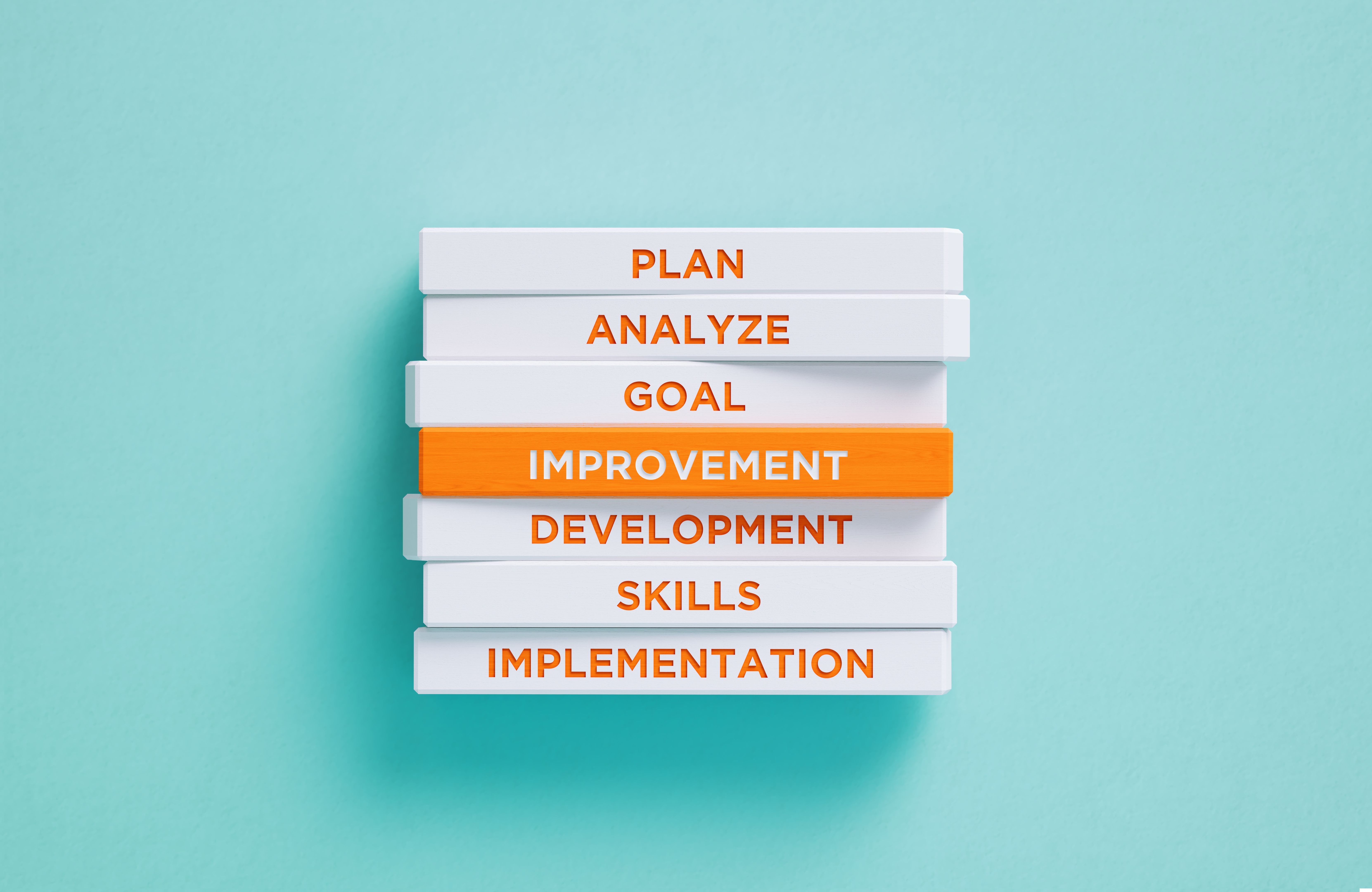 Improvement Related Words Written Wood Blocks On Blue Background - Improvement Concept