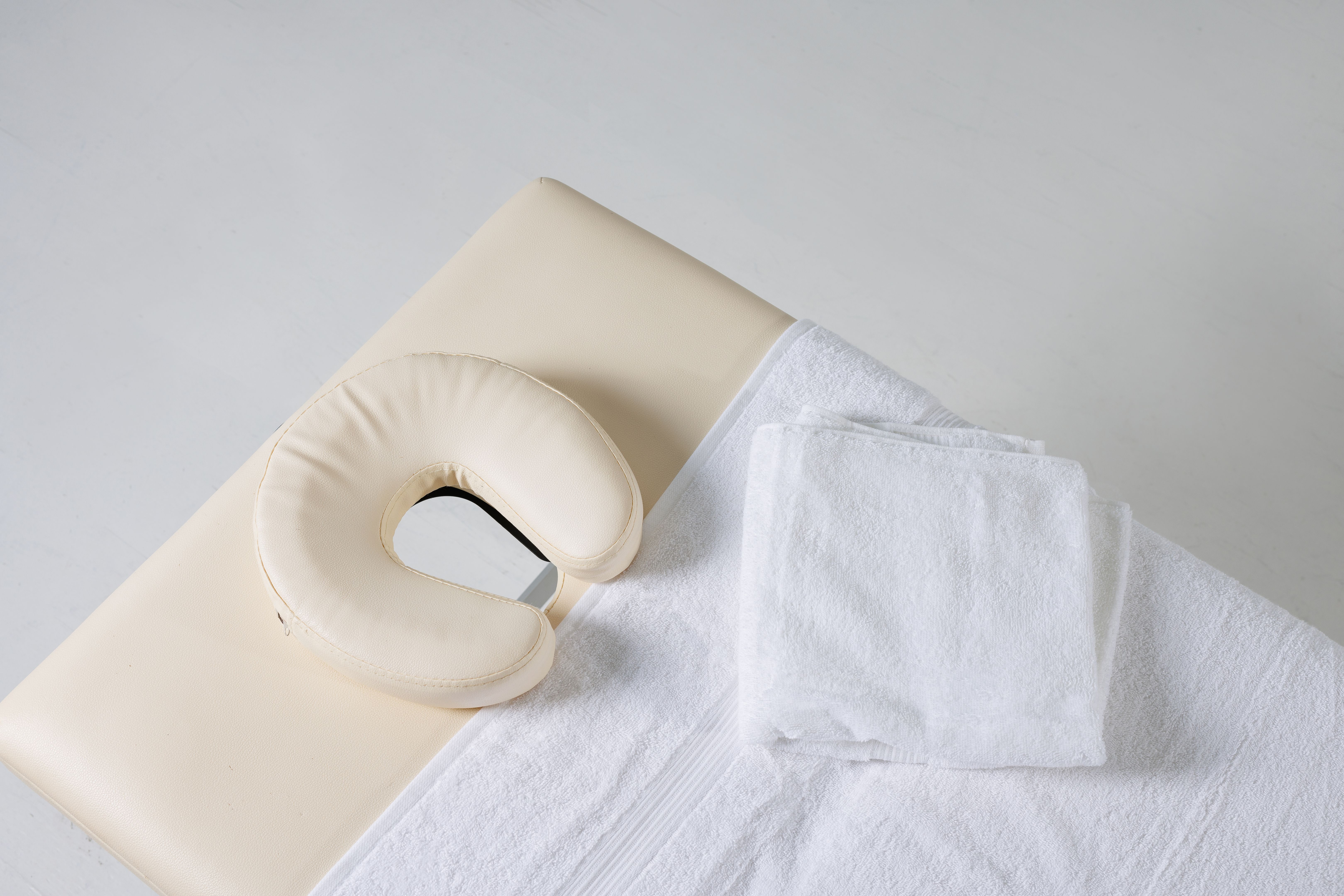 massage table top view on white background, massage therapist workplace