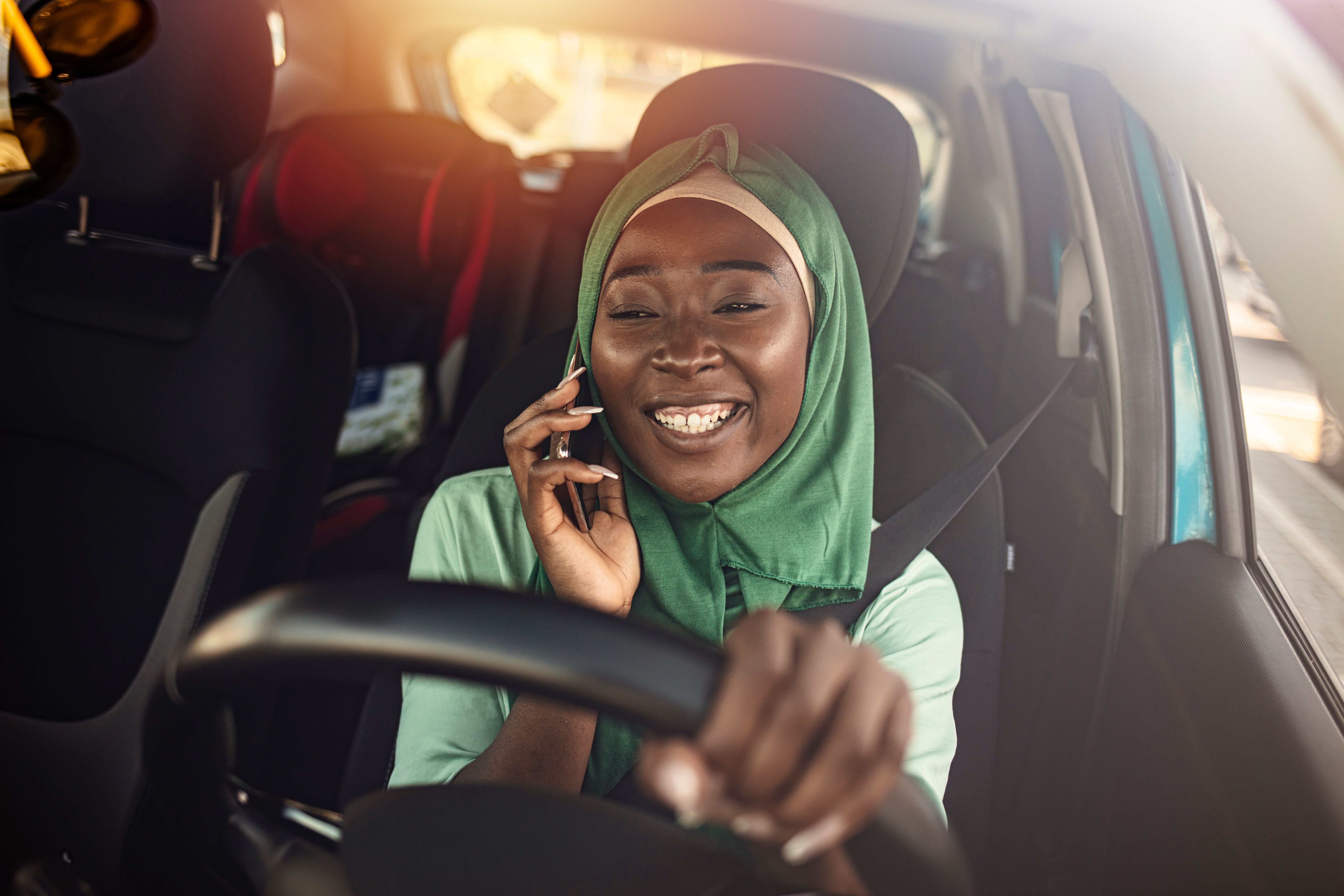 Young African Muslim woman driving a car