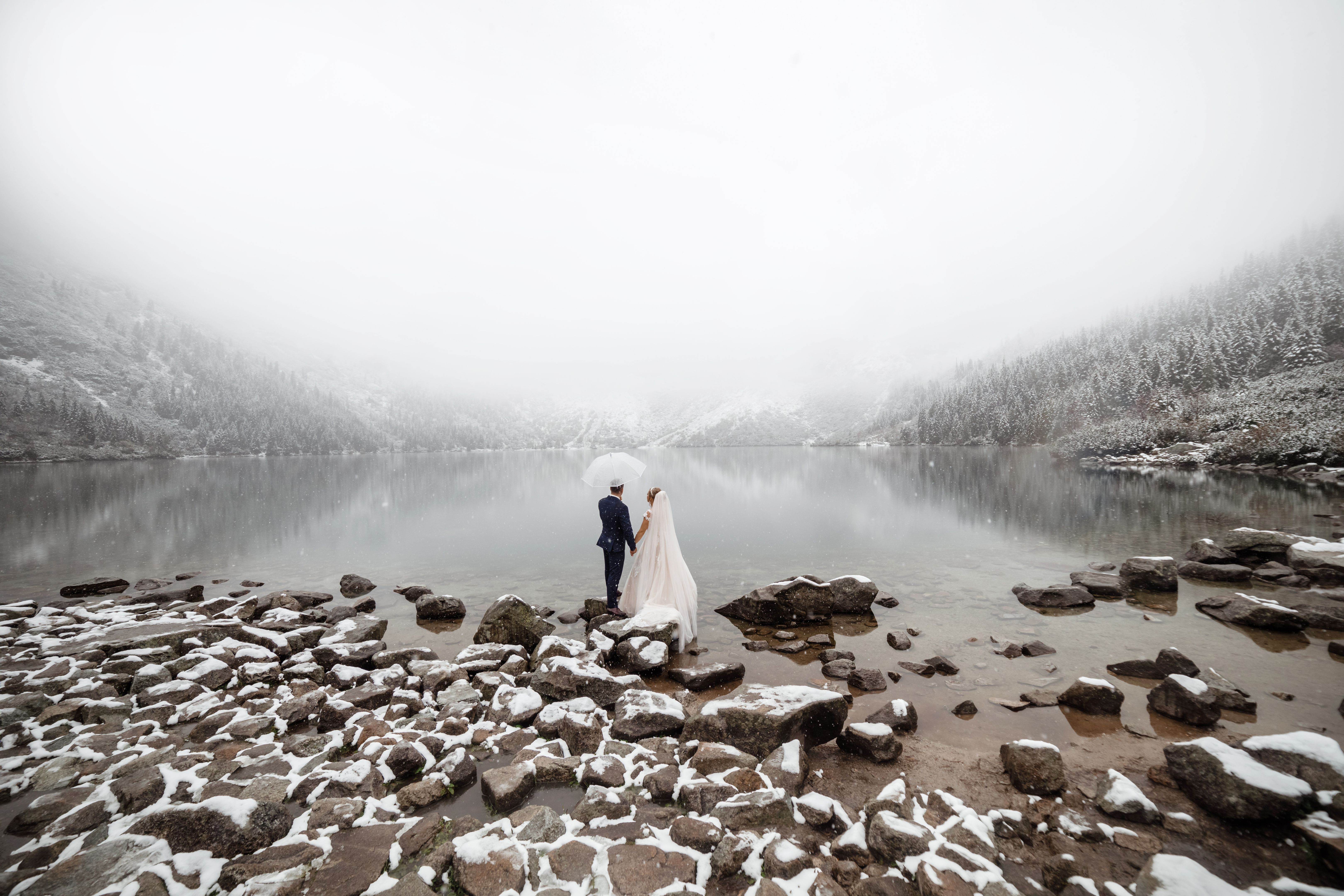 brides mountain near the lake in winter. Tender couple in love.