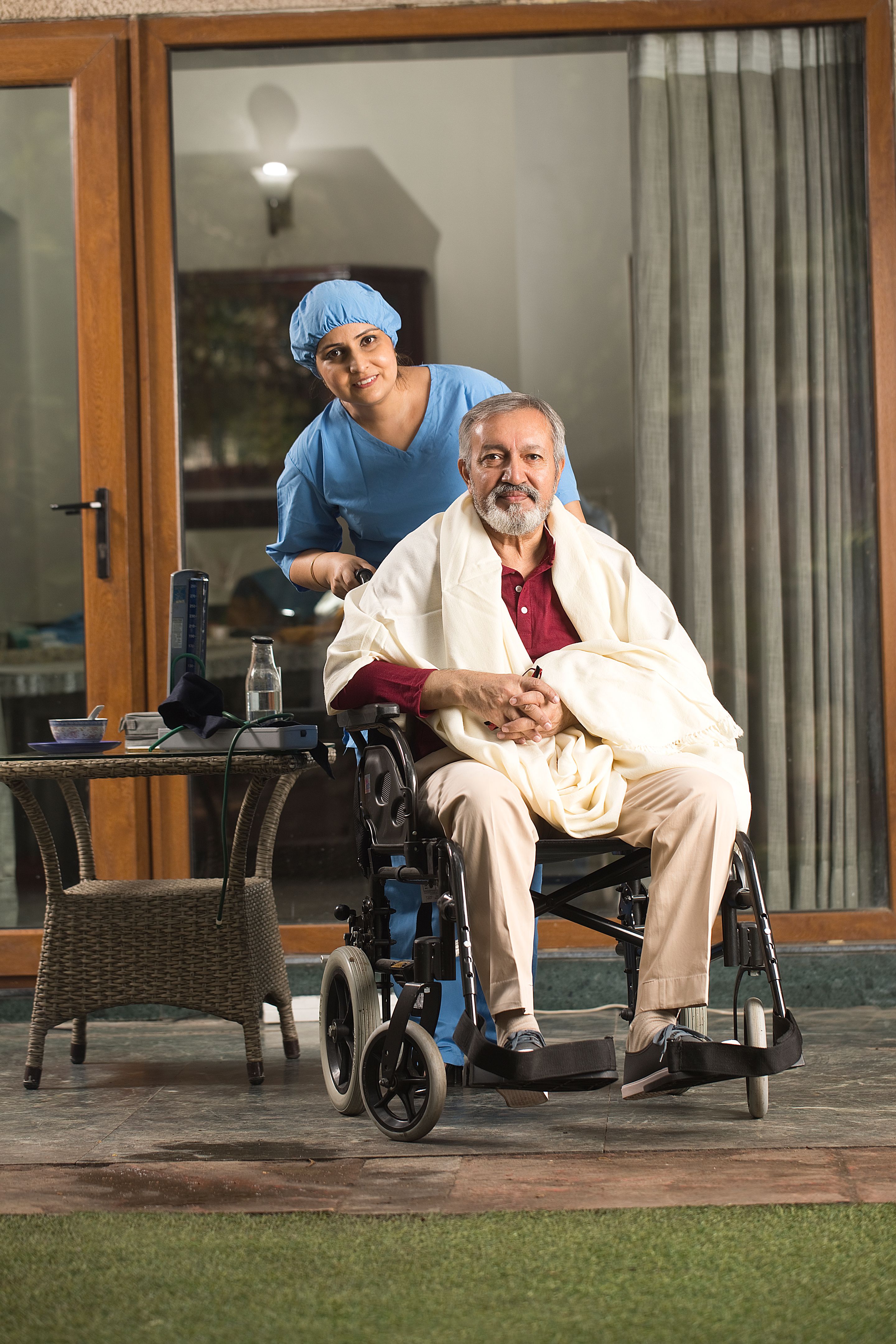 Nurse with disabled man on wheelchair