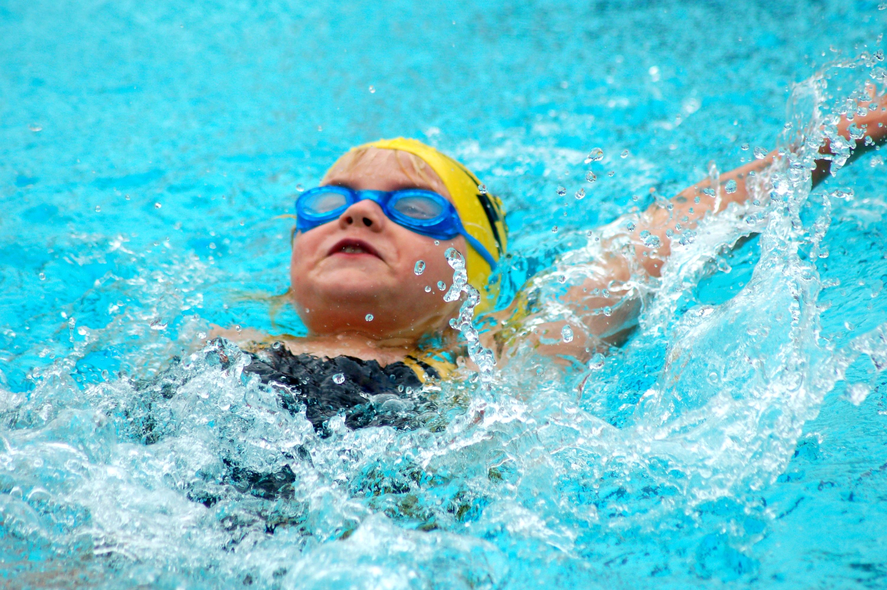 Young Swimmer Swims Backstroke