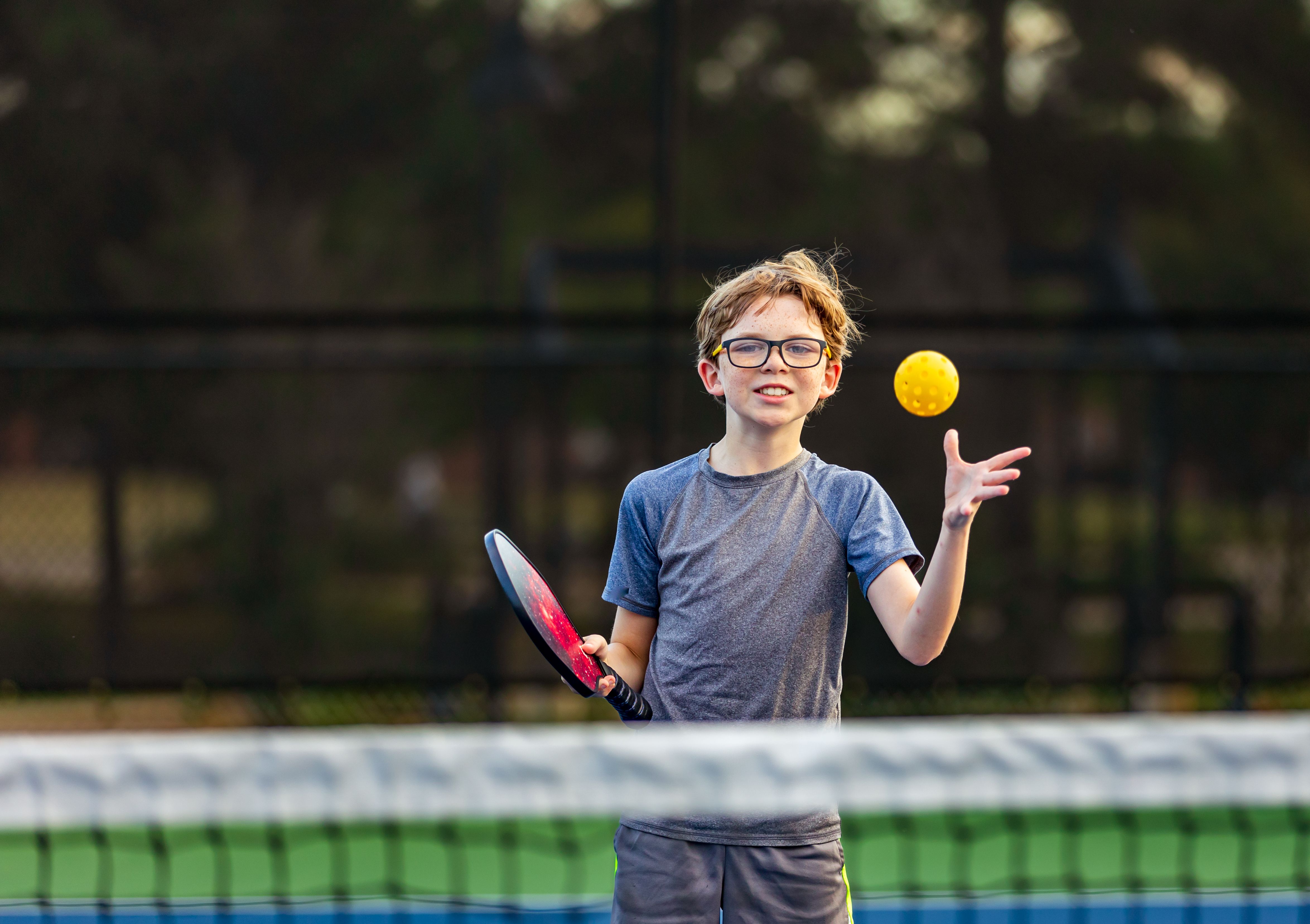 child playing tennis