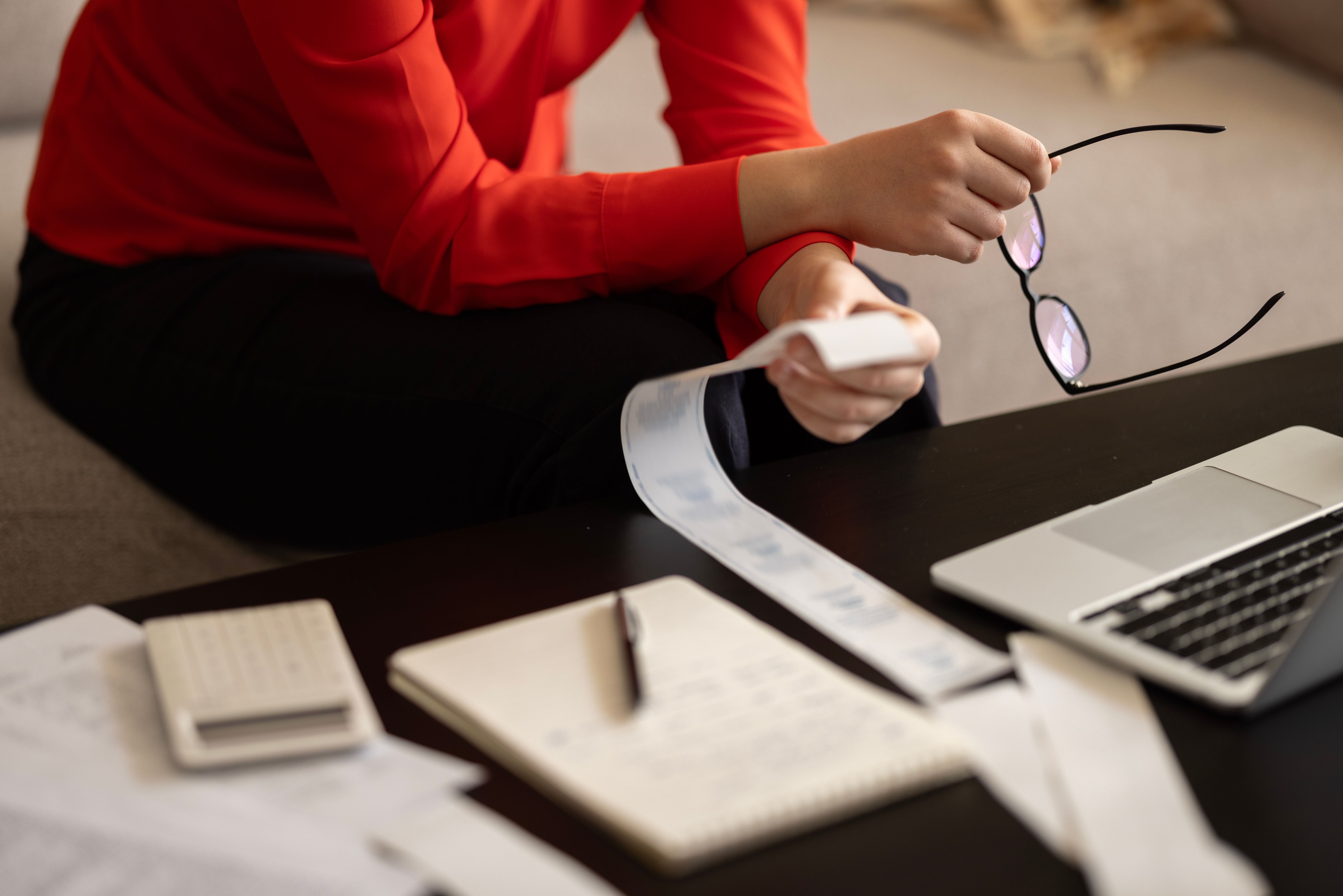 Woman is calculating the cost of the bill. Woman is calculating the cost of the bill.