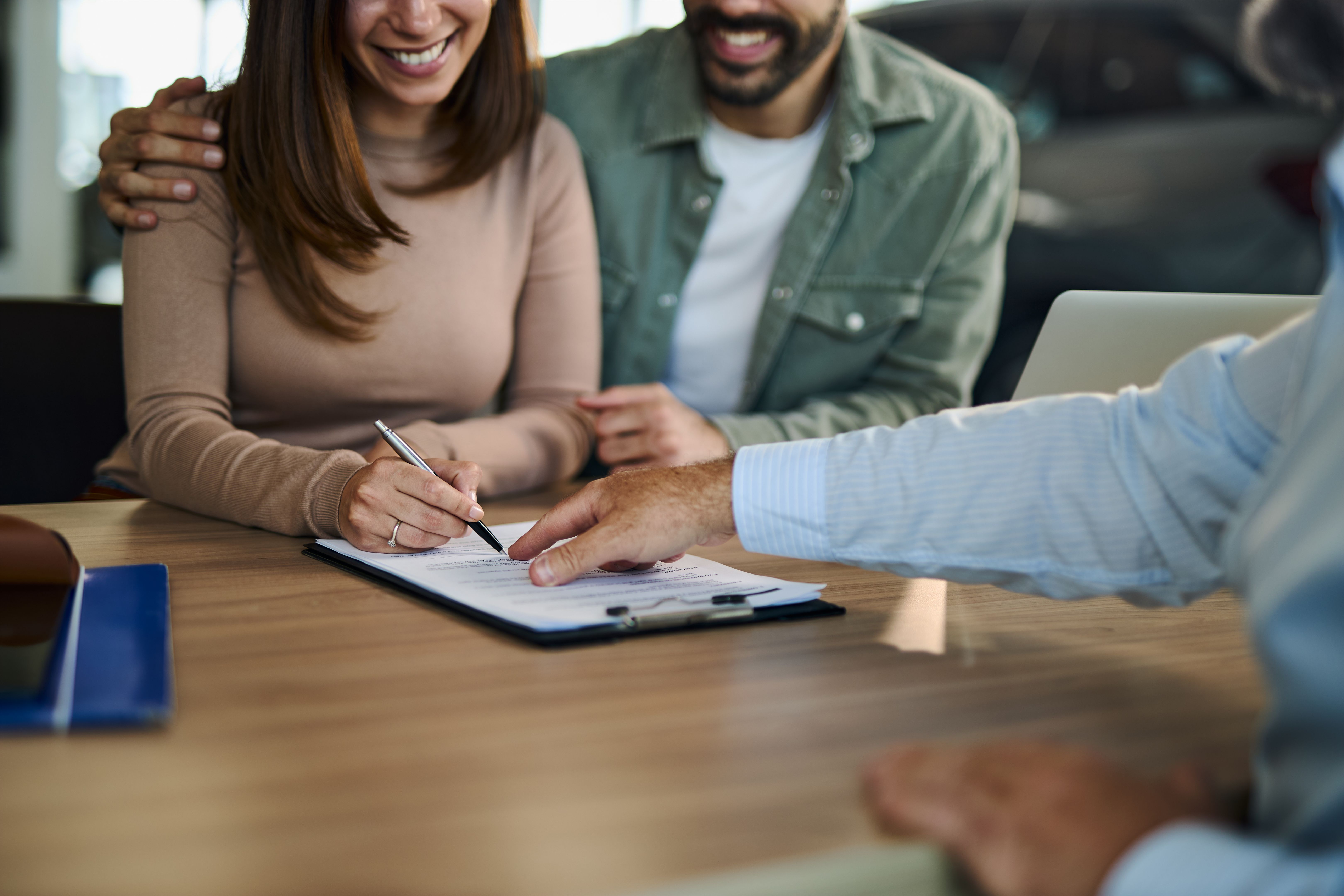happy couple signing lease