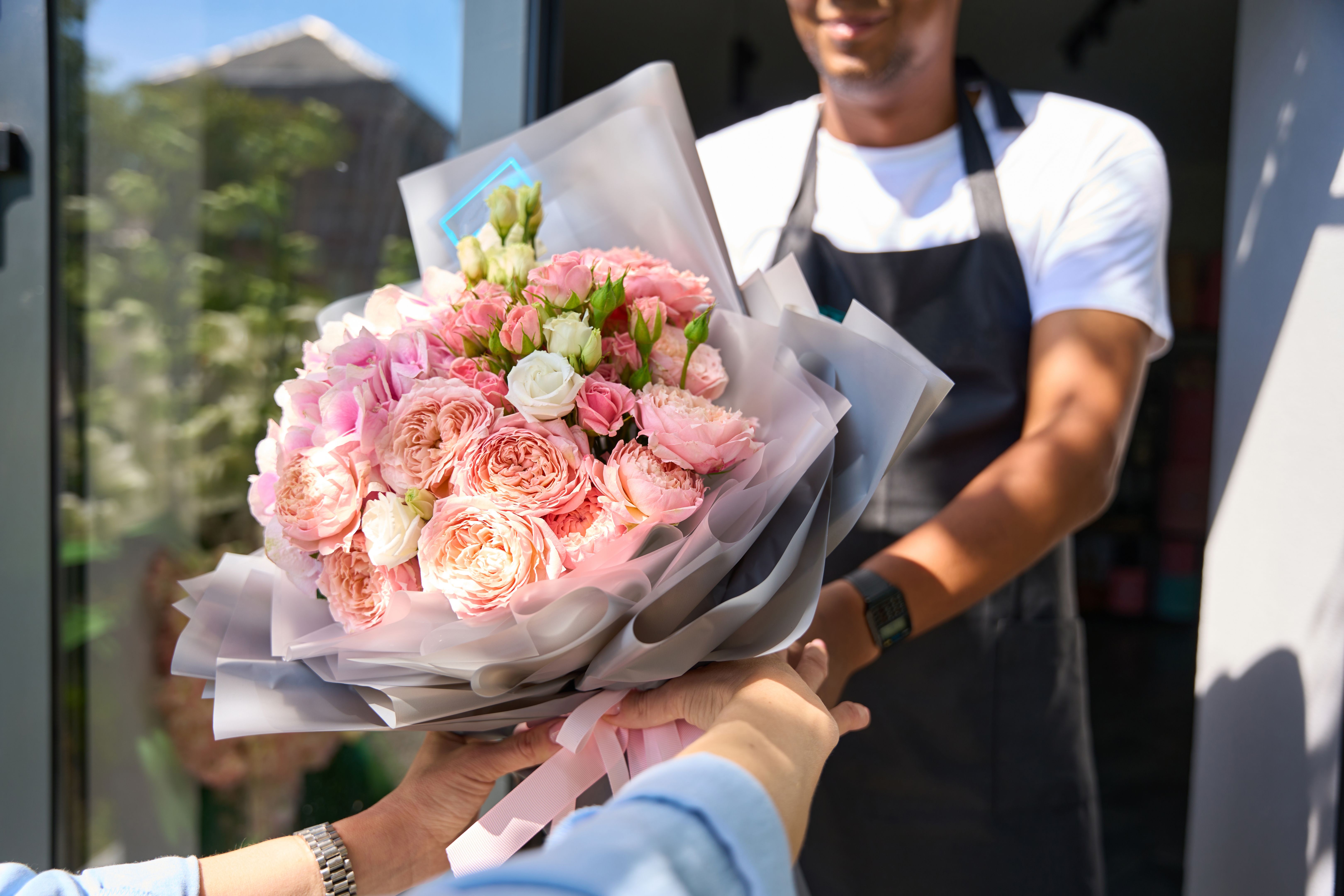 Buyer takes a beautiful bouquet from the seller