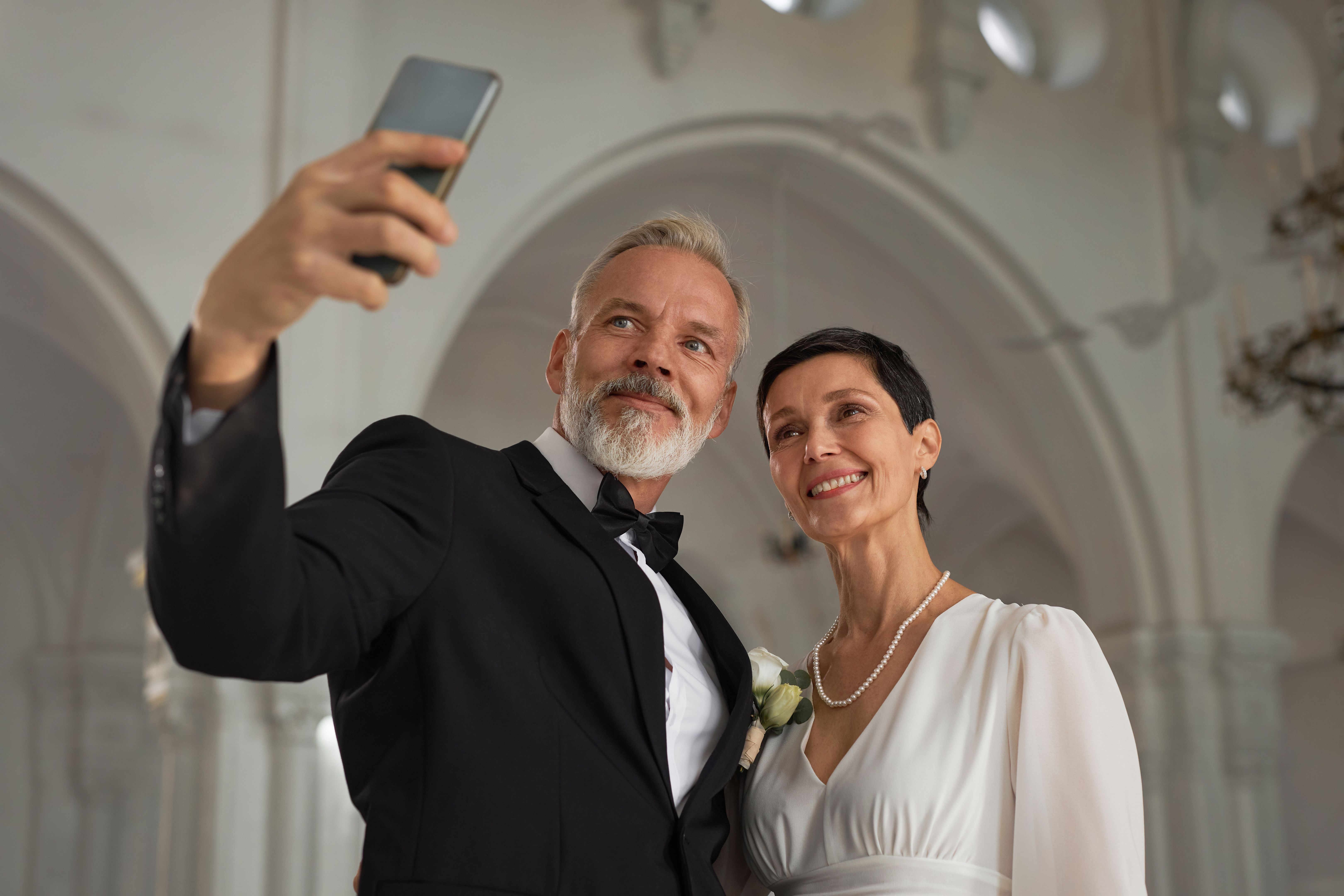 Senior Bride and Groom Taking Selfie Photo Together