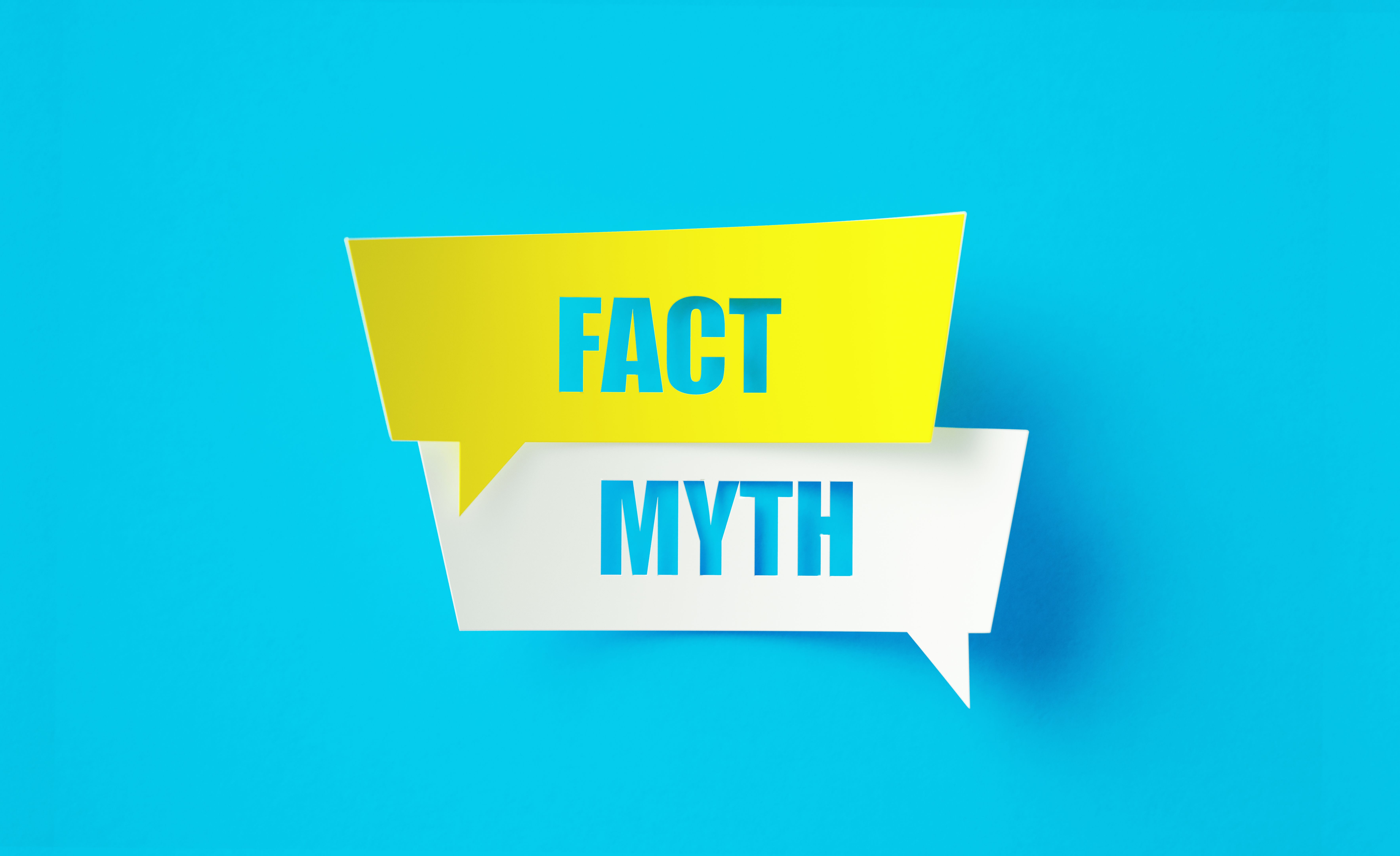 Fact Myth Written Cut Out Yellow And White Speech Bubbles Sitting Over Blue Background Fact Myth Written Cut Out Yellow And White Speech Bubbles Sitting Over Blue Background