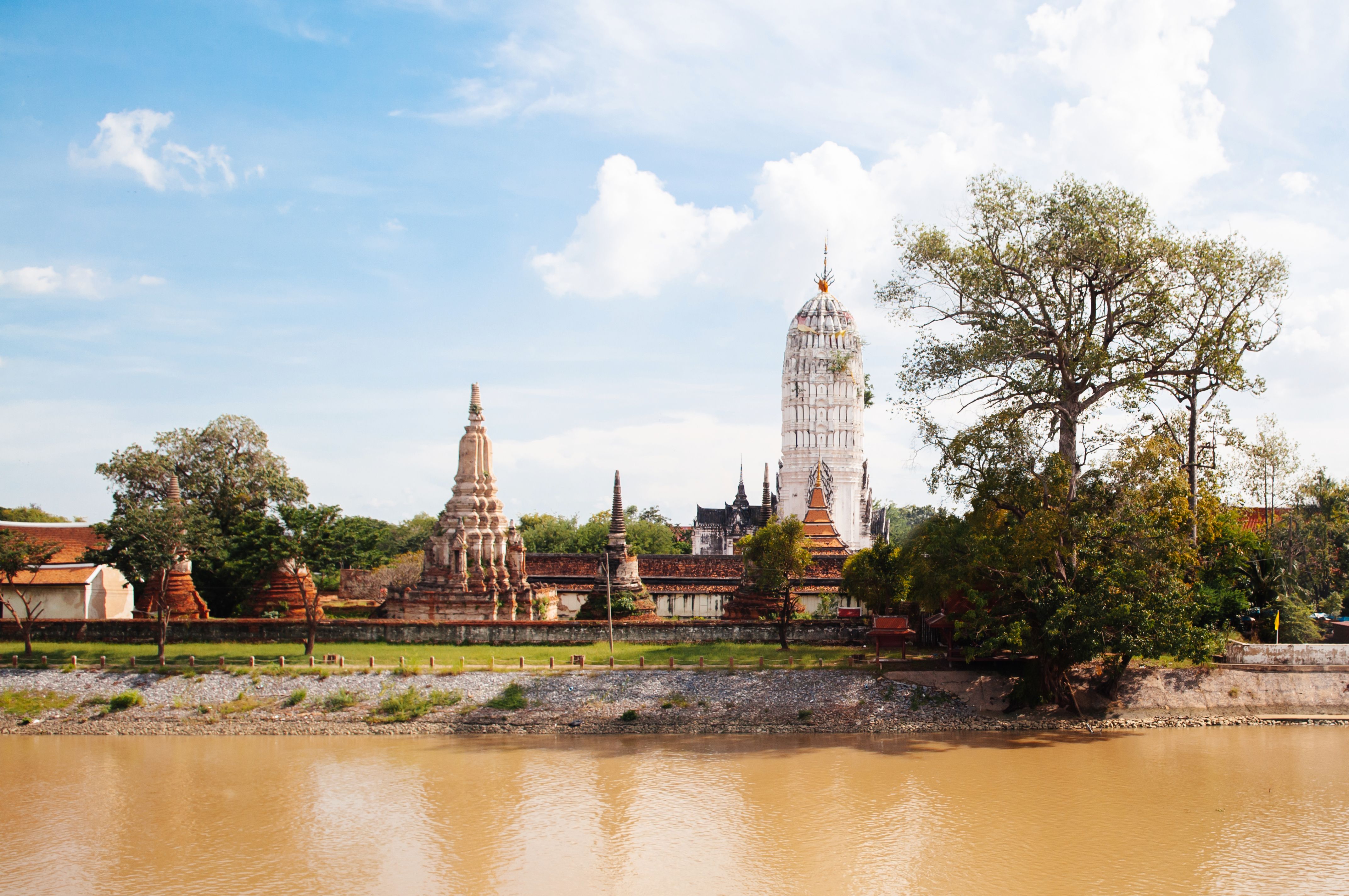 Ayutthaya ancient Buddhist pagodas among ruined brick wall of Wat Putthaisawan temple Ayutthaya ancient Buddhist pagodas among ruined brick wall of Wat Putthaisawan temple