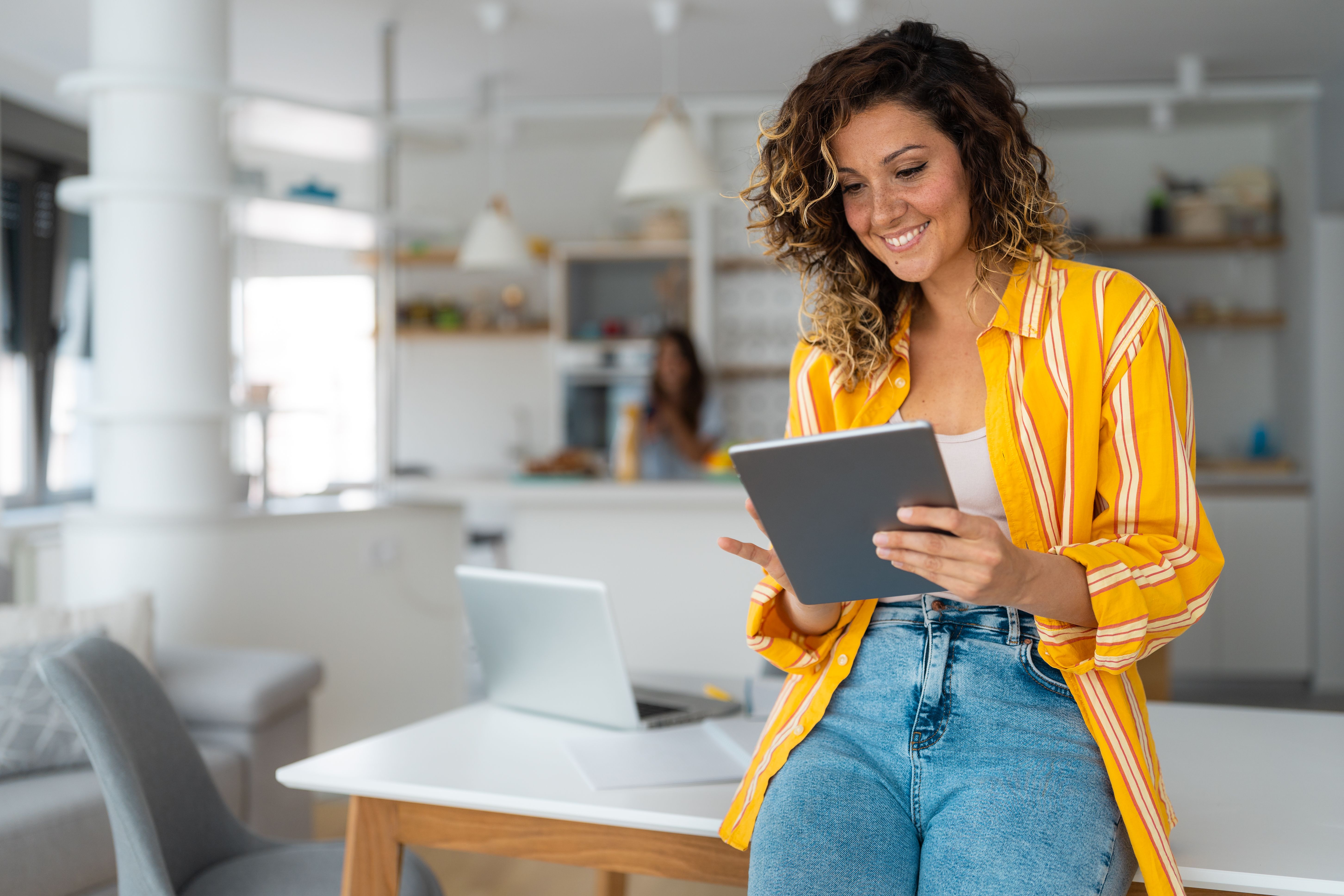 Professional businesswoman looking at tablet screen distantly working from home Professional businesswoman looking at tablet screen distantly working from home