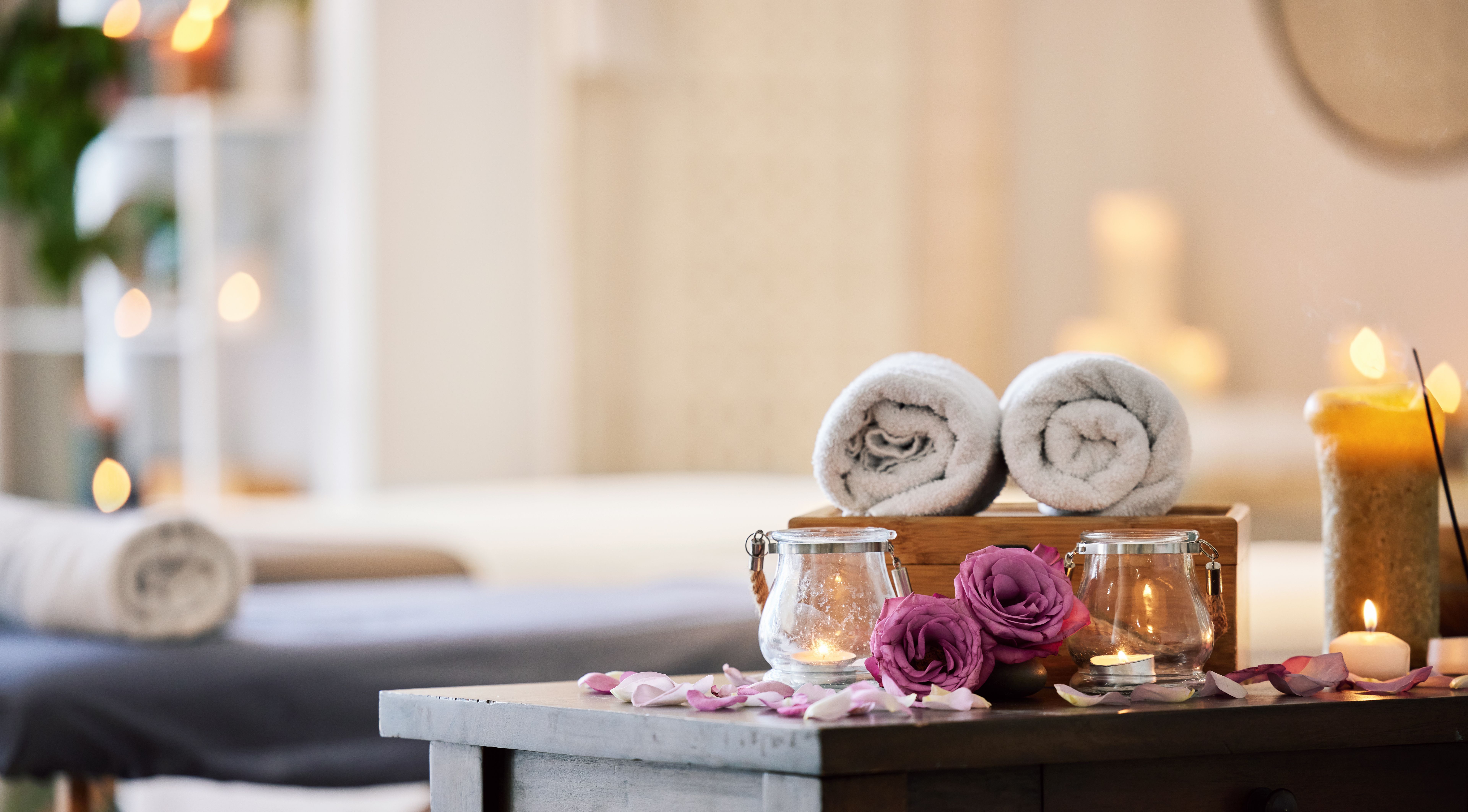 Relax, peace and calm at a luxury spa for wellness, health and zen during a massage. Candles, flowers and healing environment at a salon for stress relief, relaxation and physical therapy on vacation