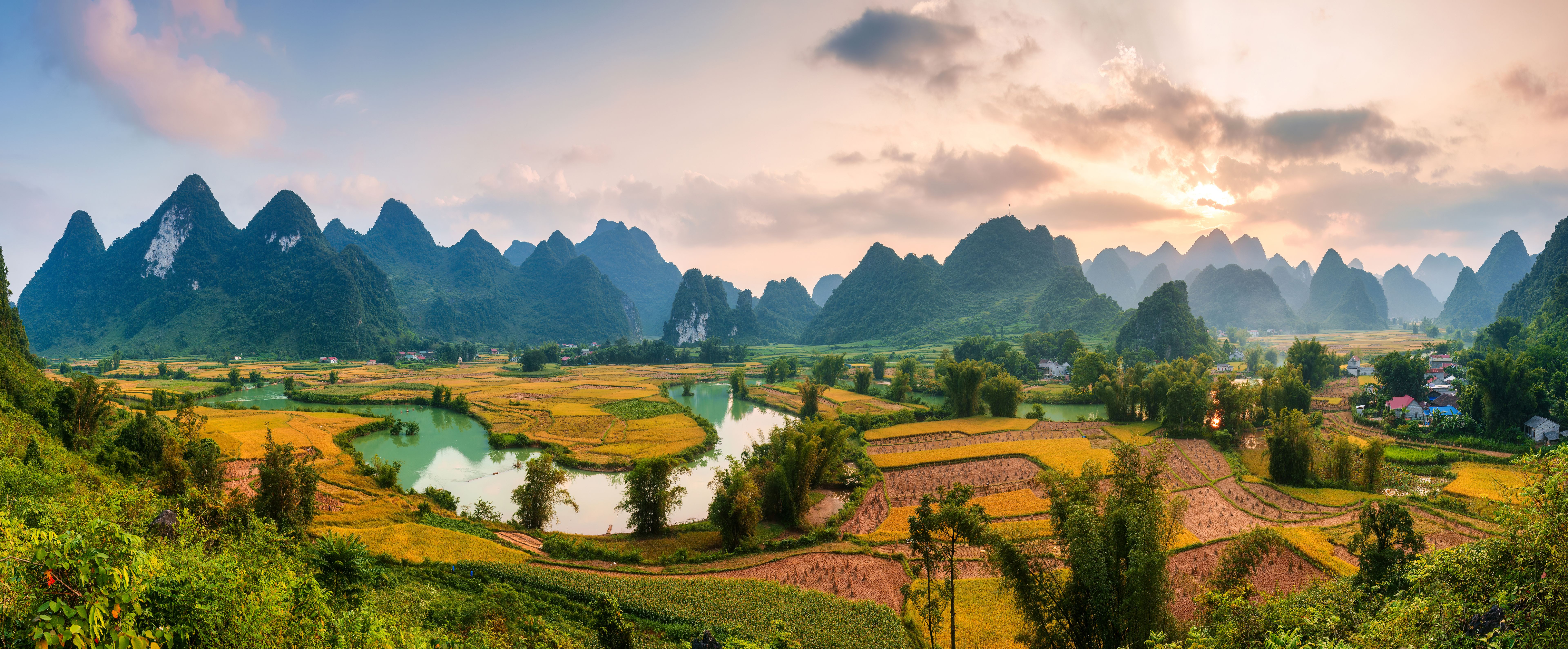Phong Nam Valley with rice field and river flows through traditional village in countryside