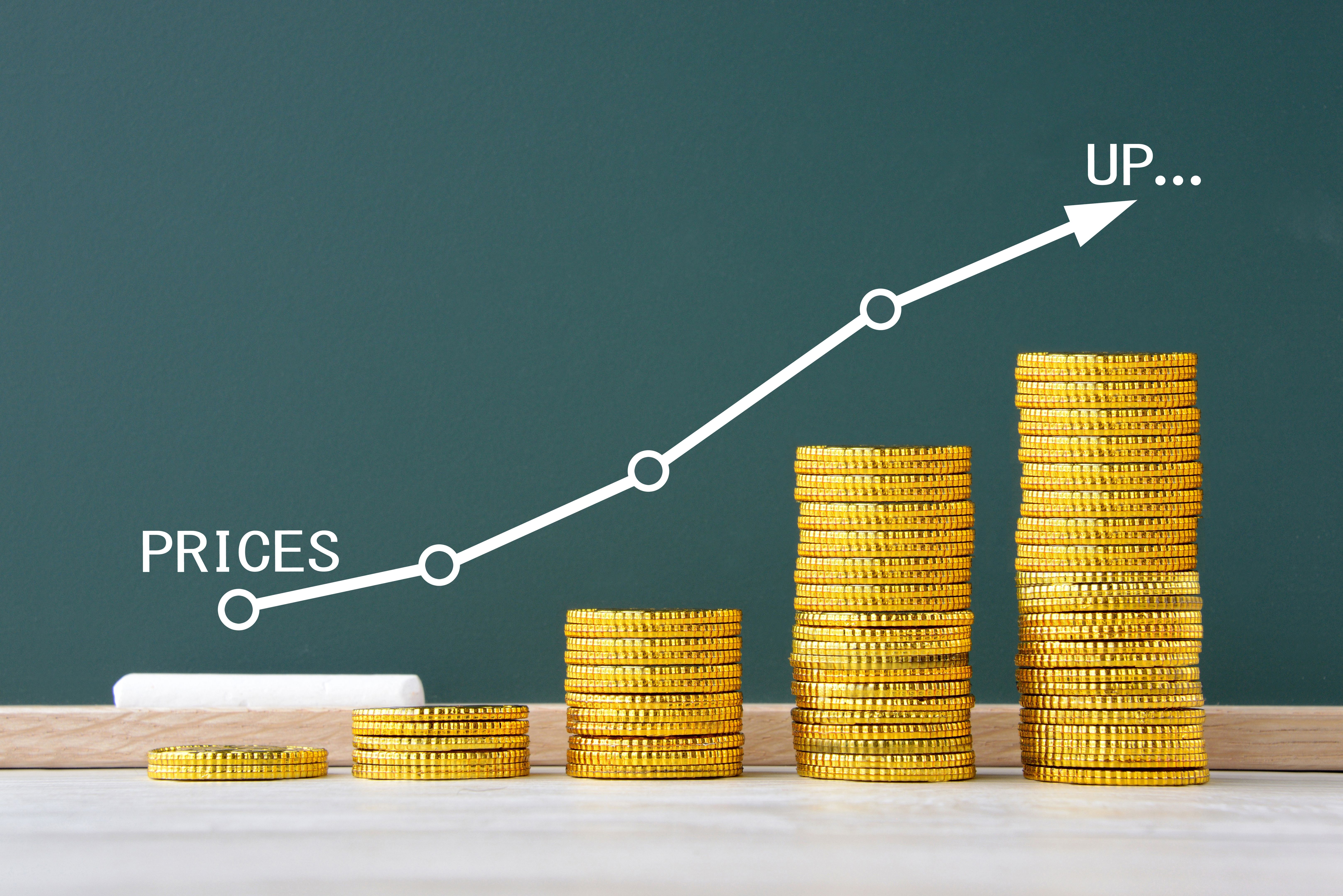 Handwritten graph for price on blackboard and coins