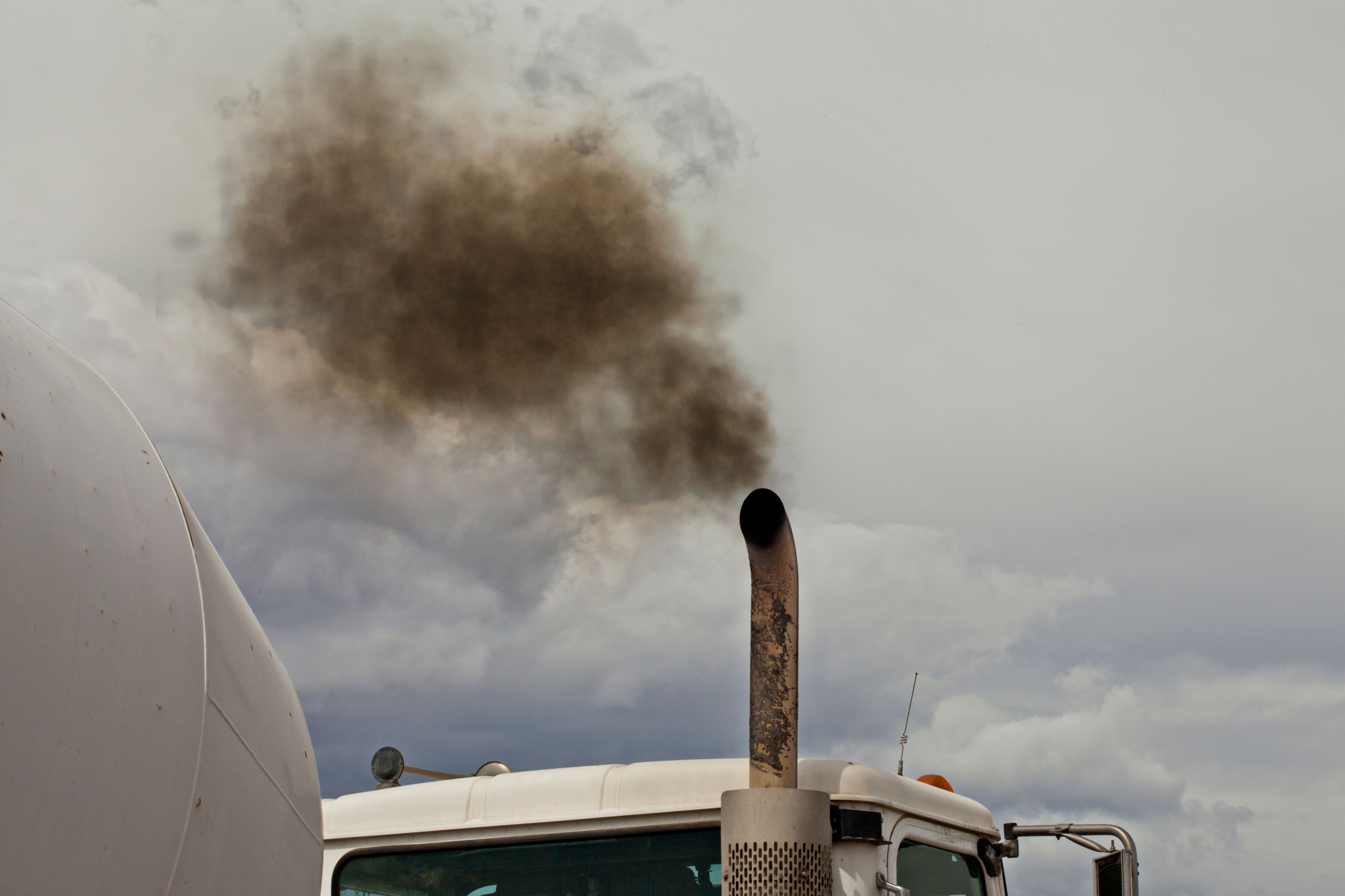 Color Image of Black Exhaust From a White Truck