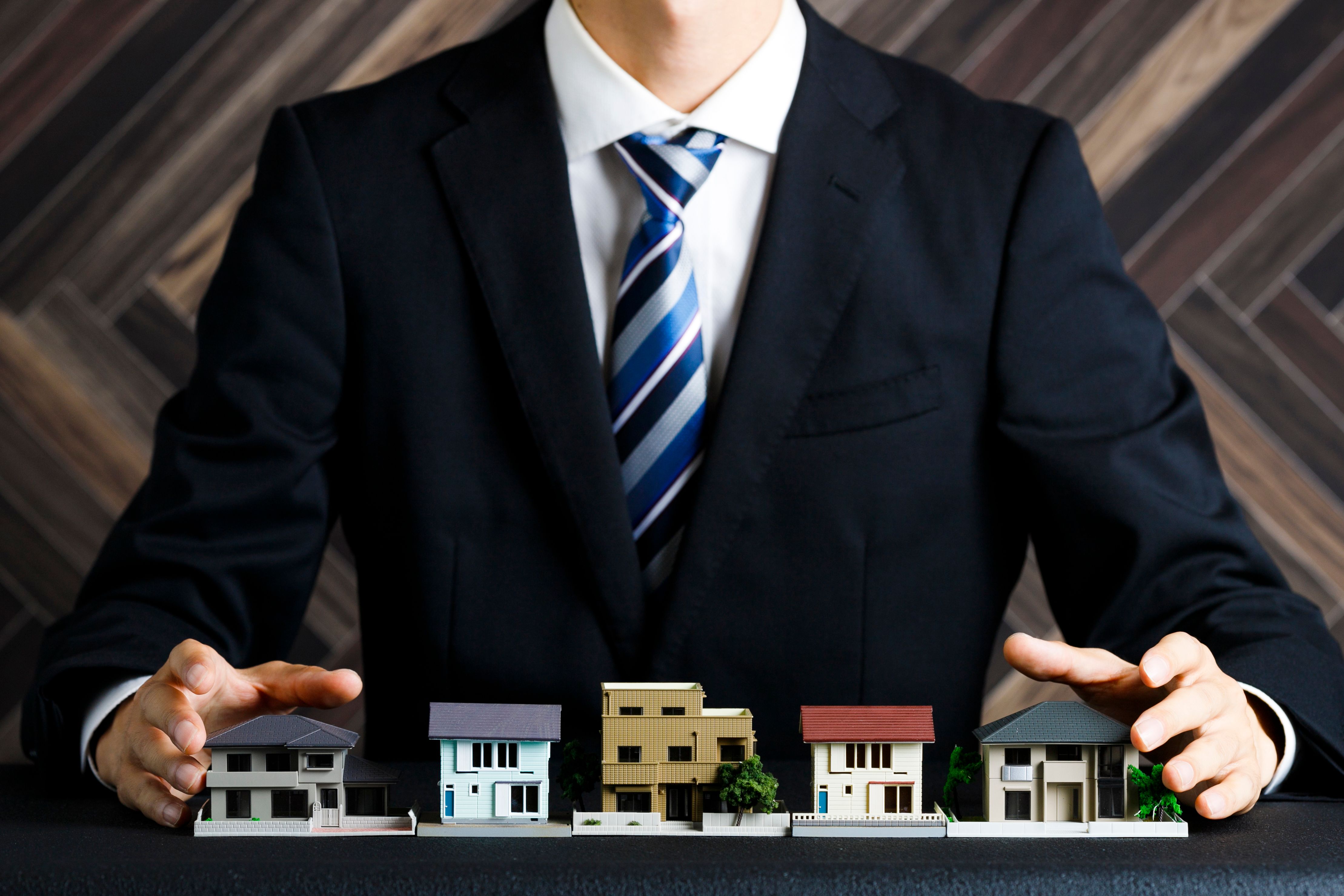 Businessman with house model and suit