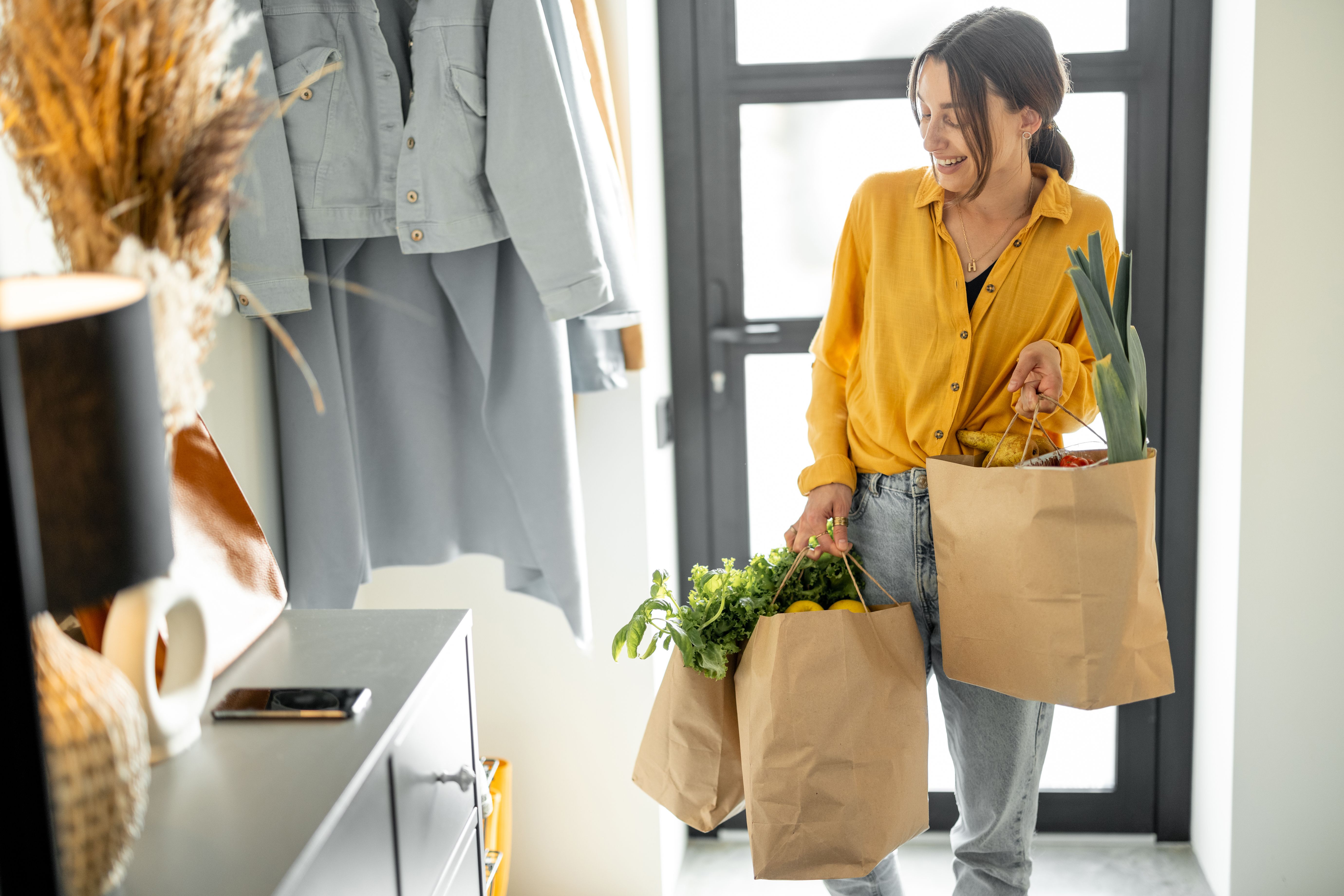 Woman comes home with bags full of fresh groceries
