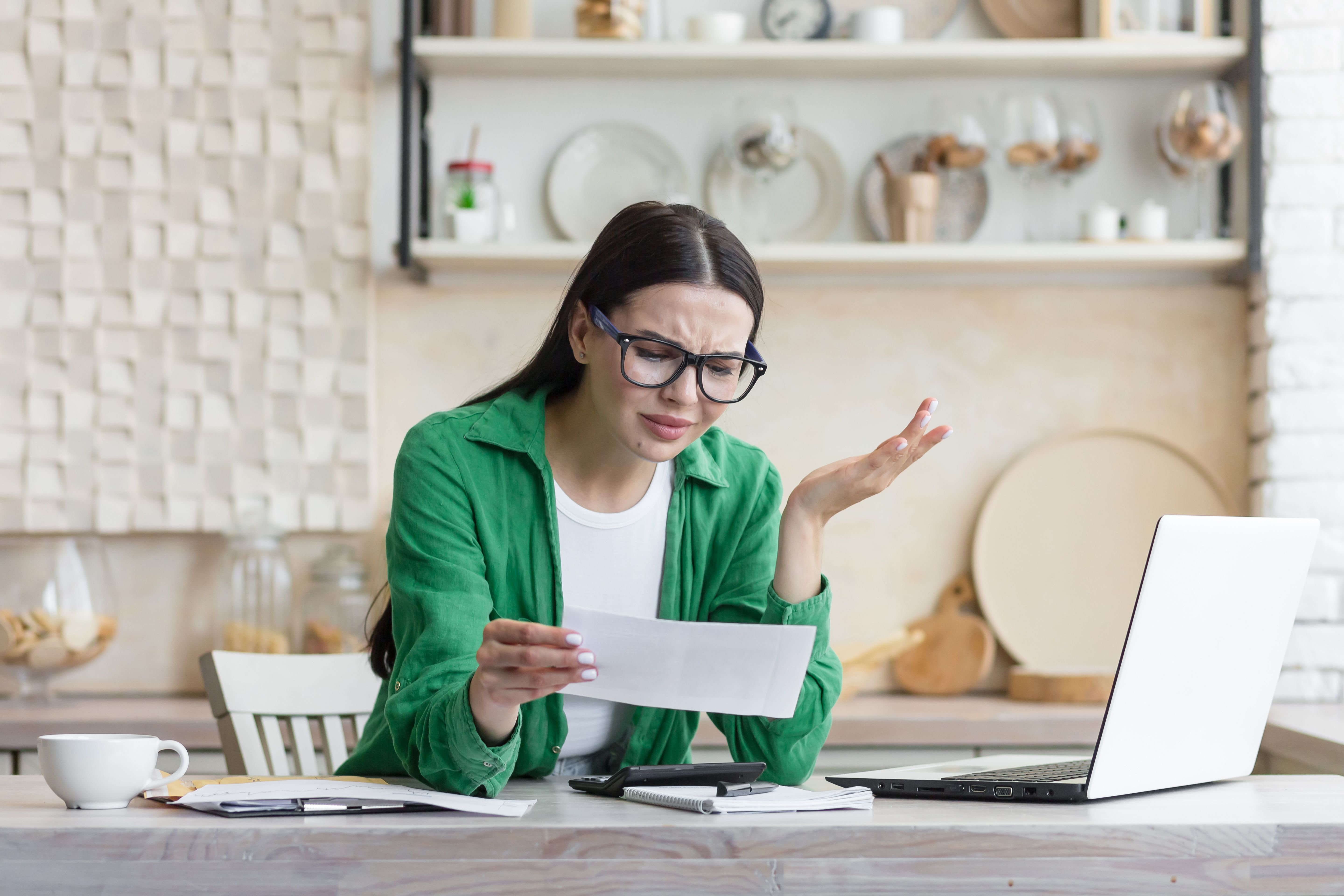 Beautiful woman in a green shirt in despair, received a letter of bad news Beautiful woman in a green shirt in despair, received a letter of bad news