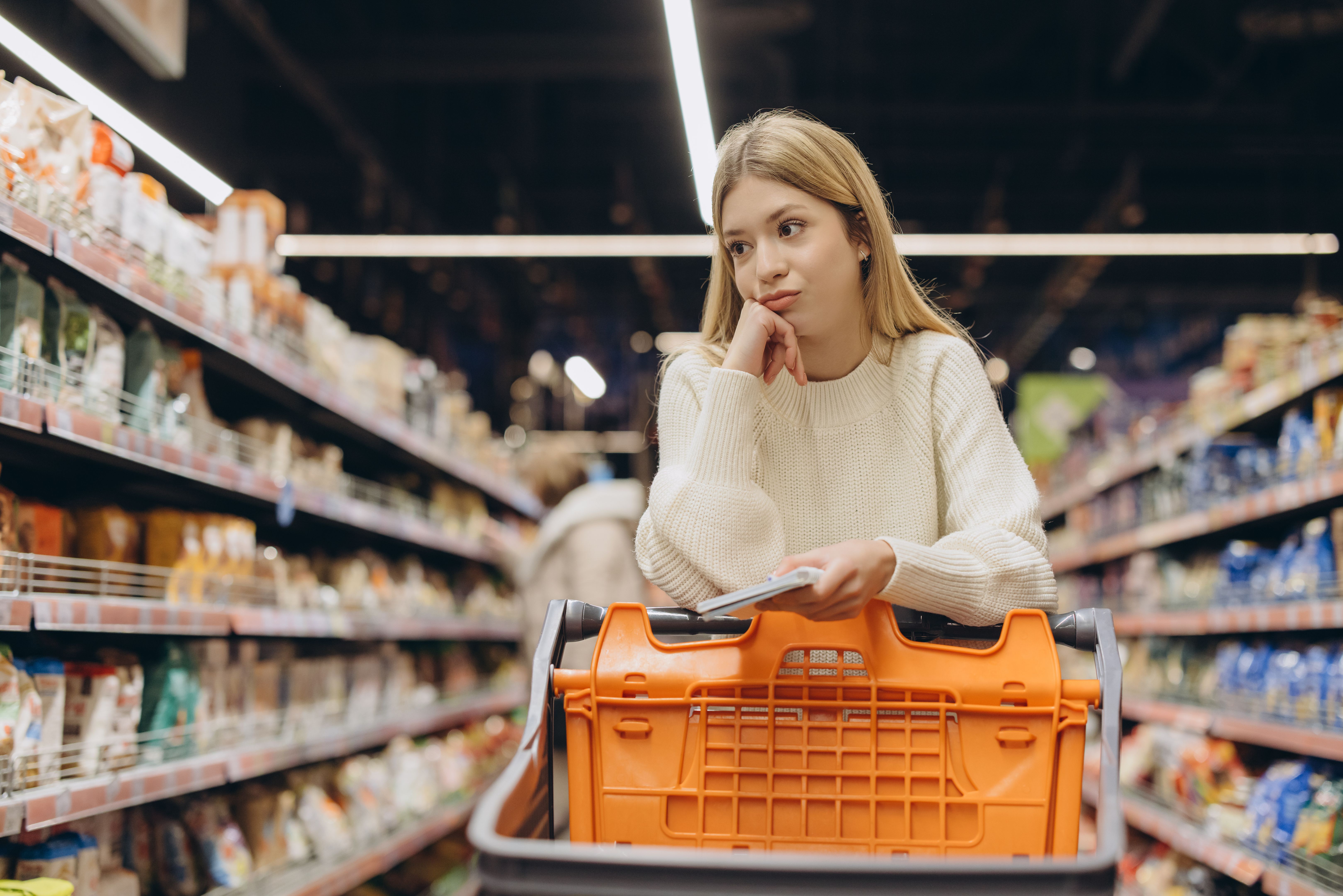 An international student browsing the supermarket for discounted items to save money