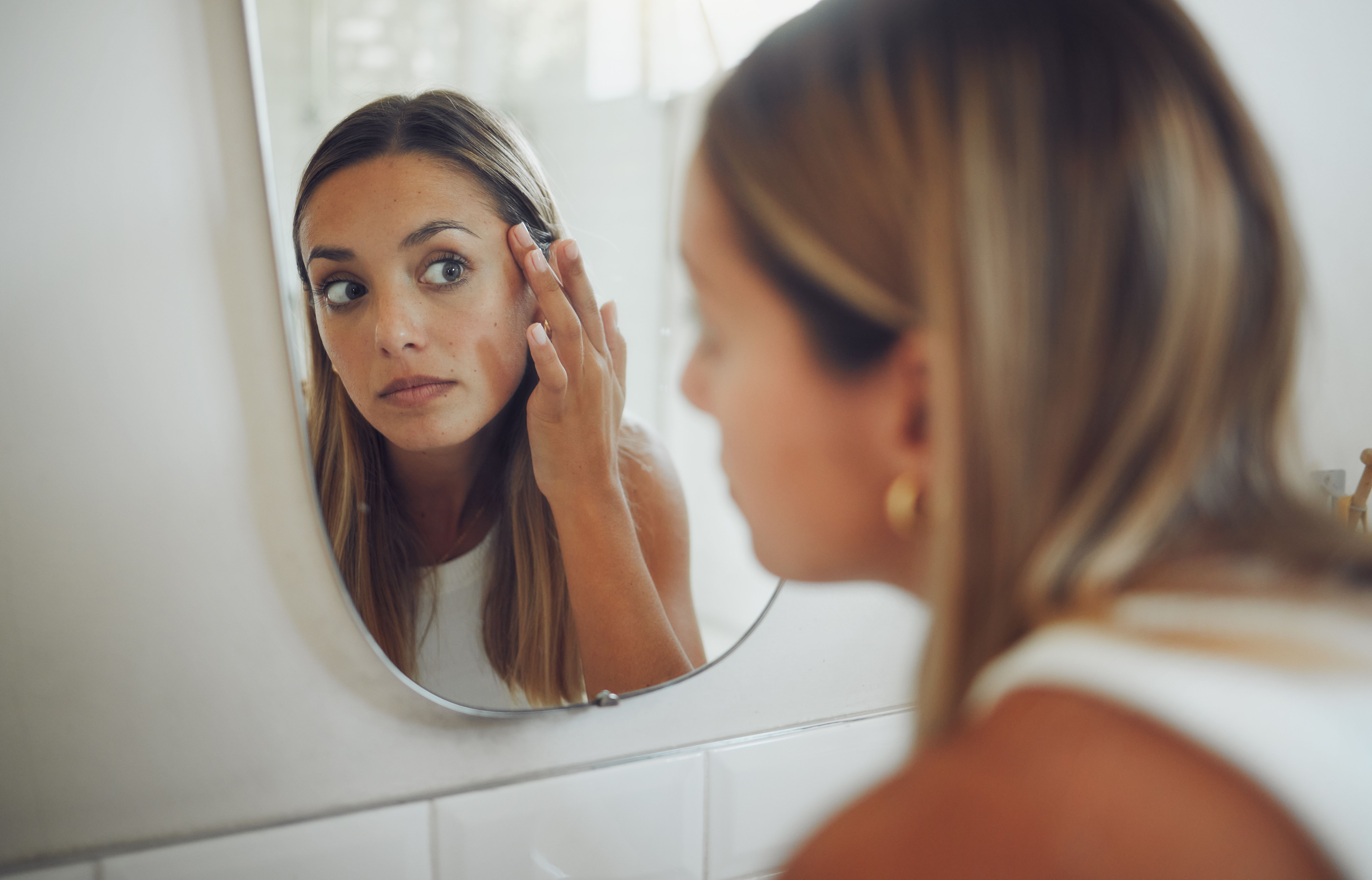 woman checking skin undertone