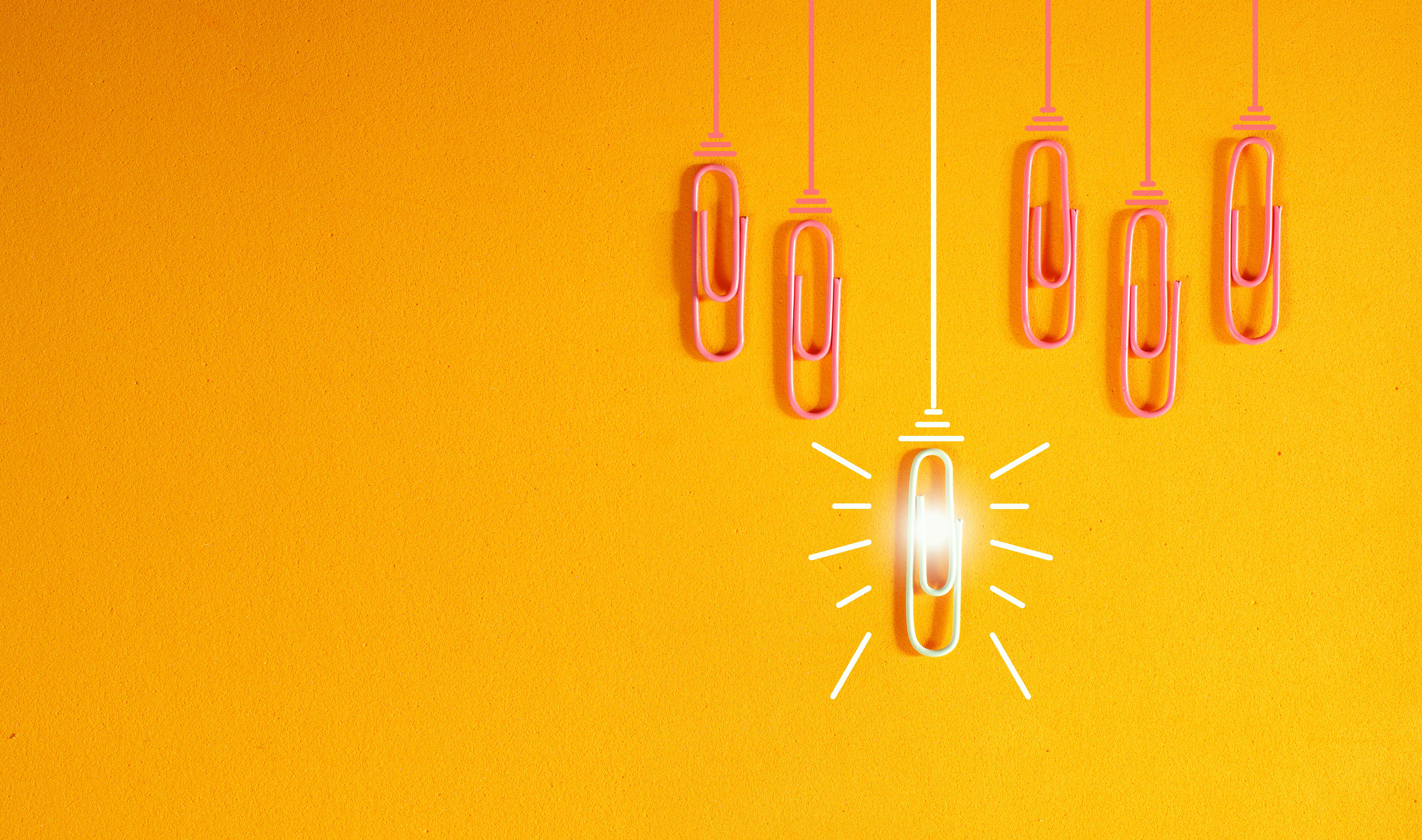 innovation concept with paperclip,thinking,creativity,light bulb on orange background,business and society concept.