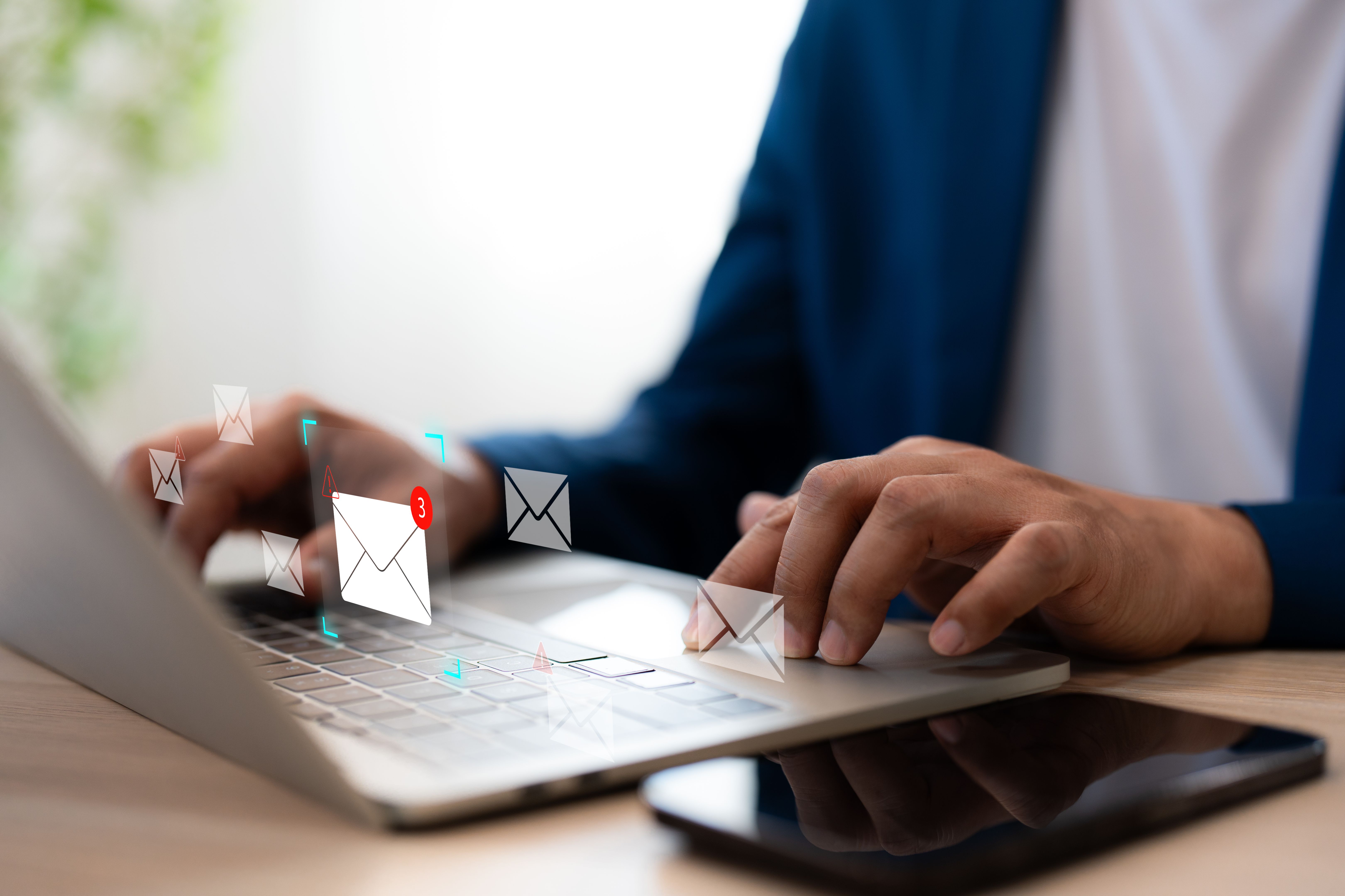Hands of A Businessman using Laptop typing on keyboard computer and surfing internet on office table with email marketing and email icon. Online working internet network concept.