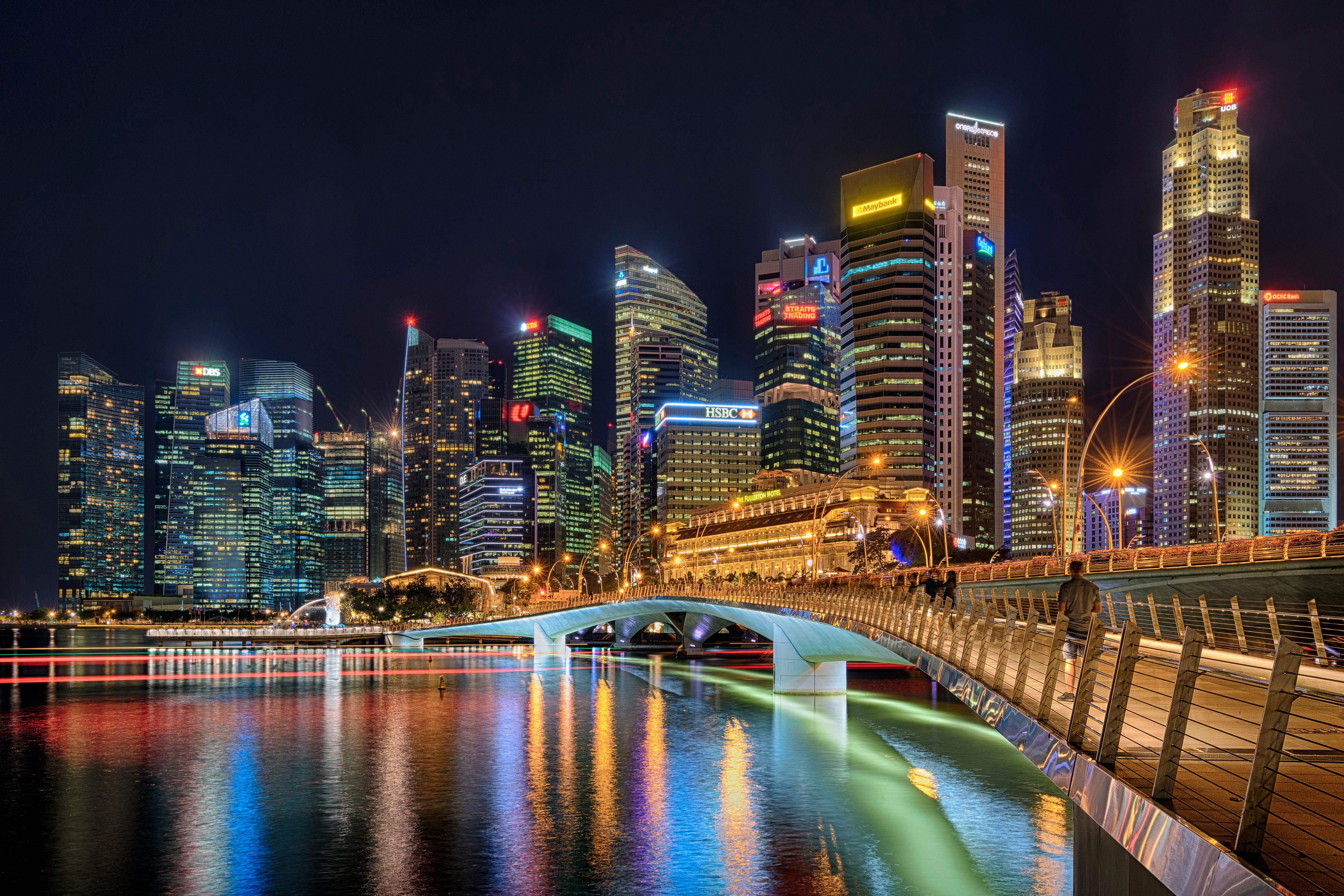 Illuminated Buildings By River Against Sky At Night