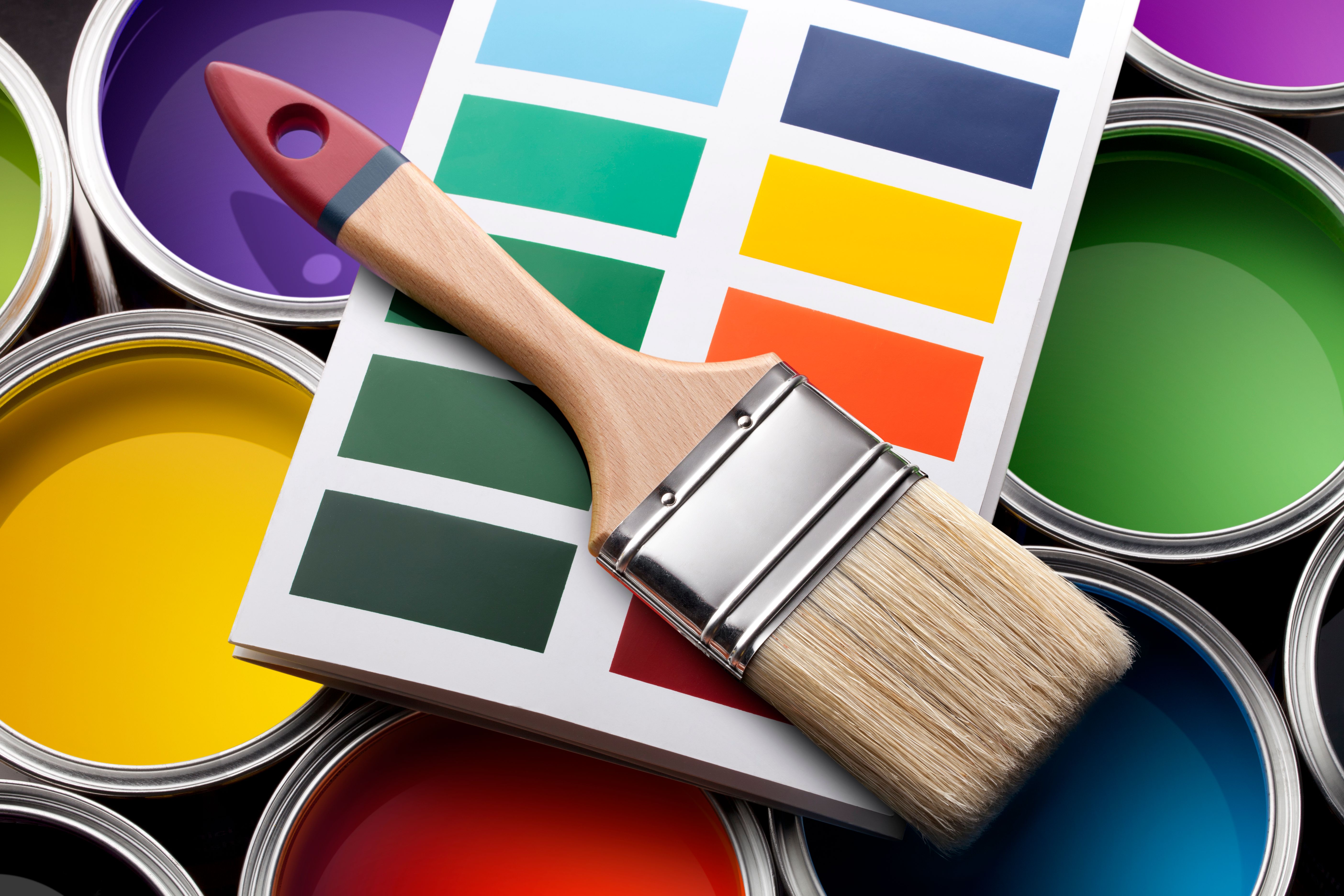Colorful paint cans with color card and brush