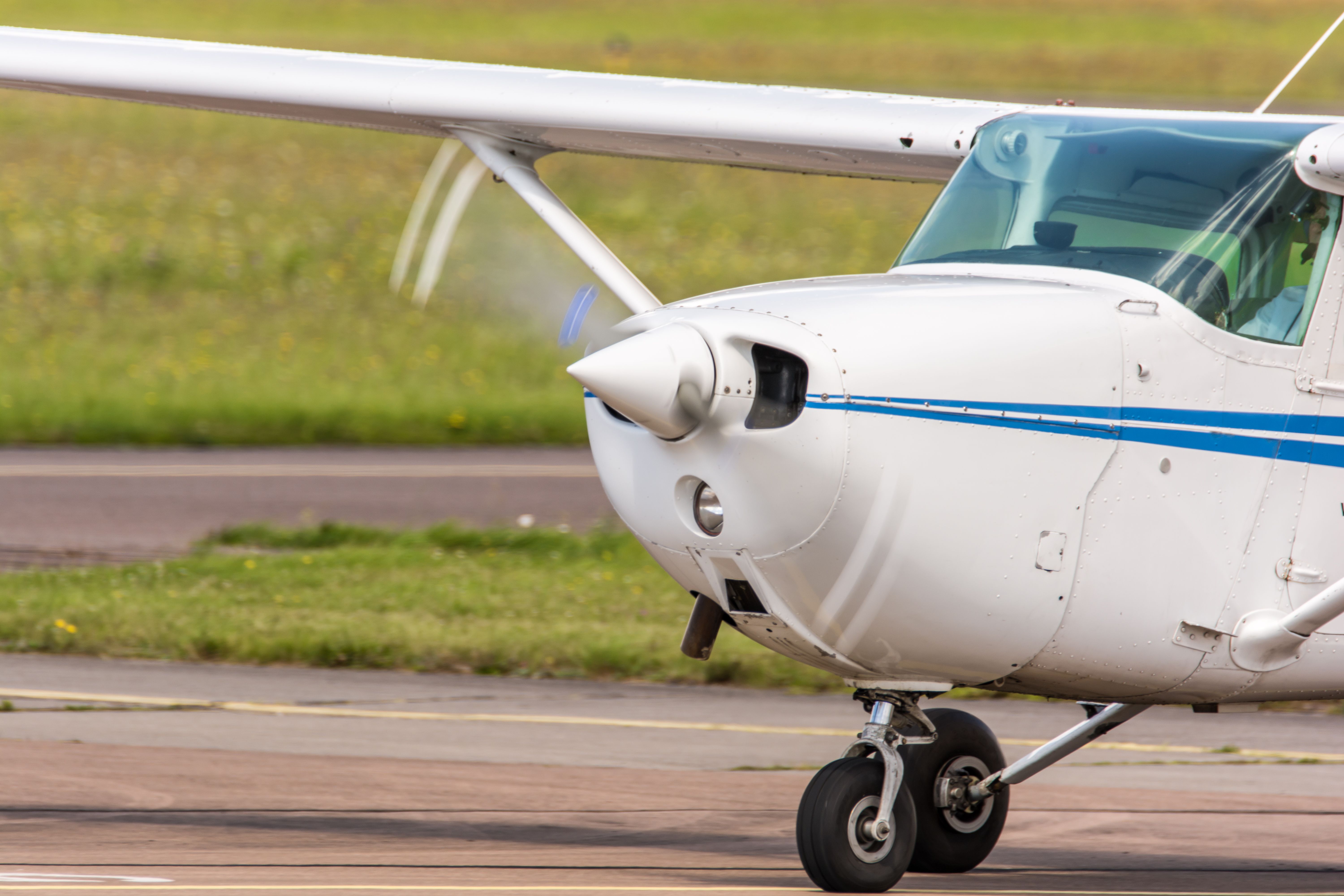 Small airplane while driving at the airport with rotating propeller