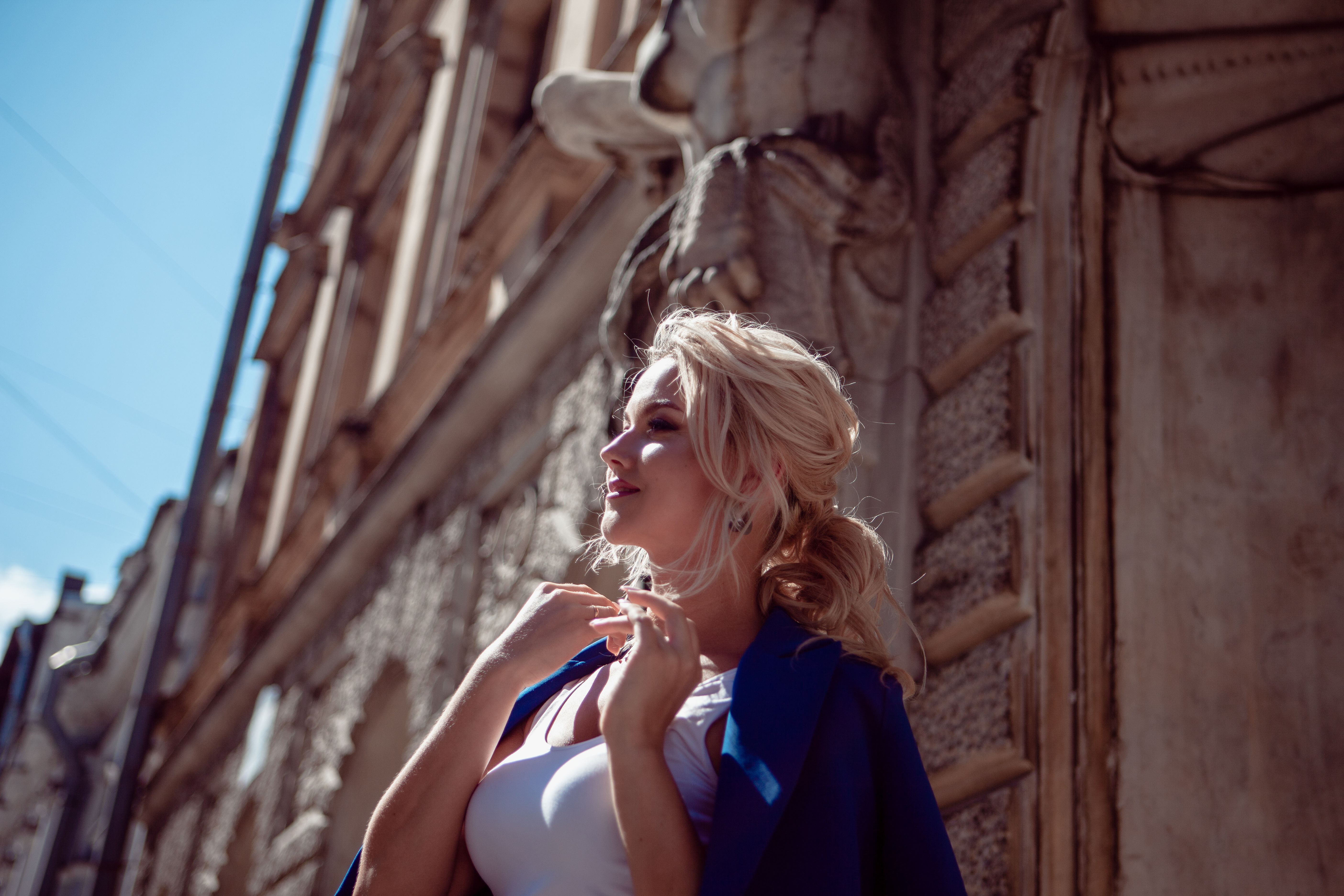 Walk through historic center. A beautiful girl, in a blue jacket against background of historic buildings, leads along. Walk through historic center. A beautiful girl, in a blue jacket against background of historic buildings, leads along.