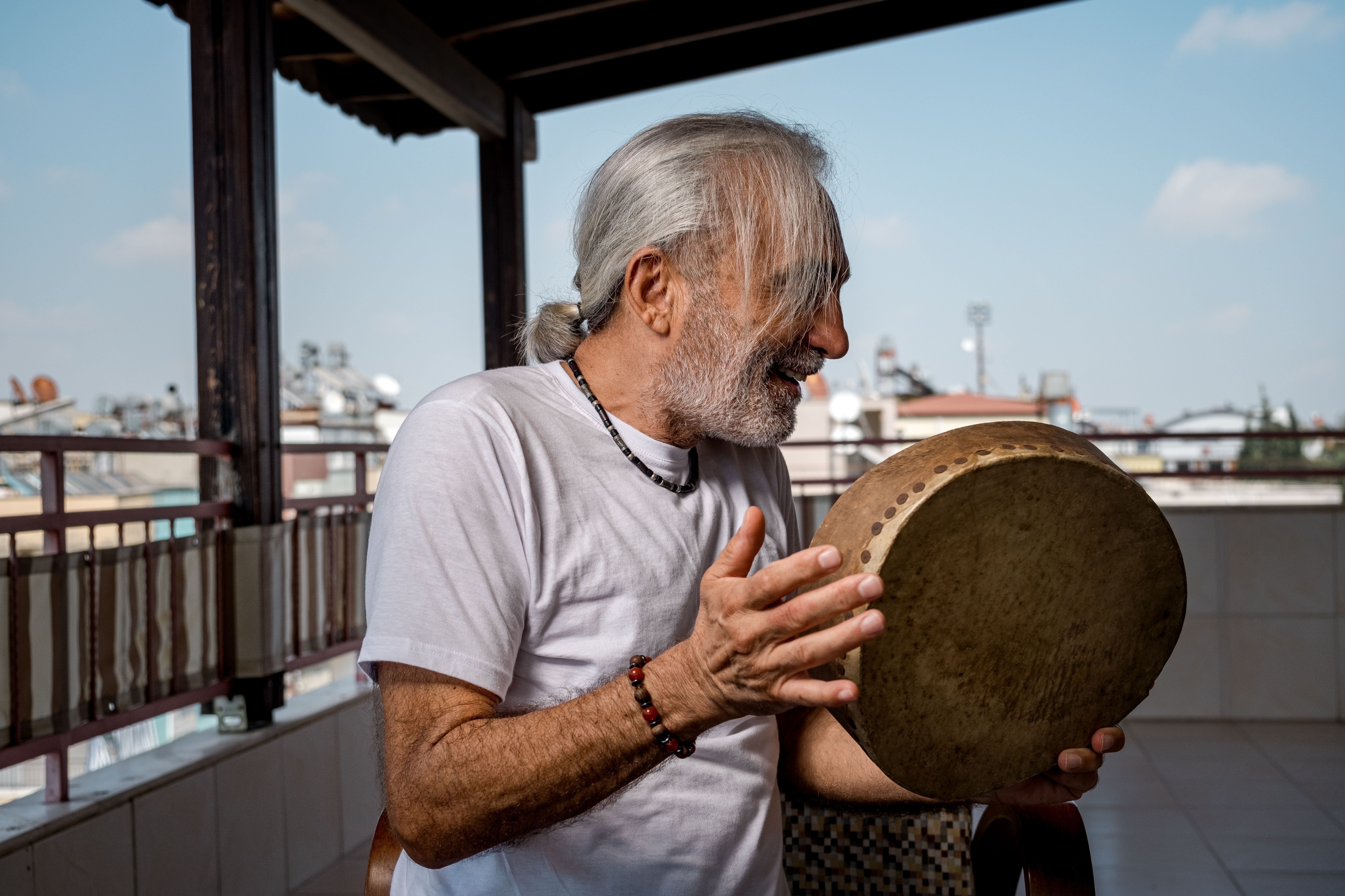 Old man with high vitality immersed in percussion instrument Old man with high vitality immersed in percussion instrument