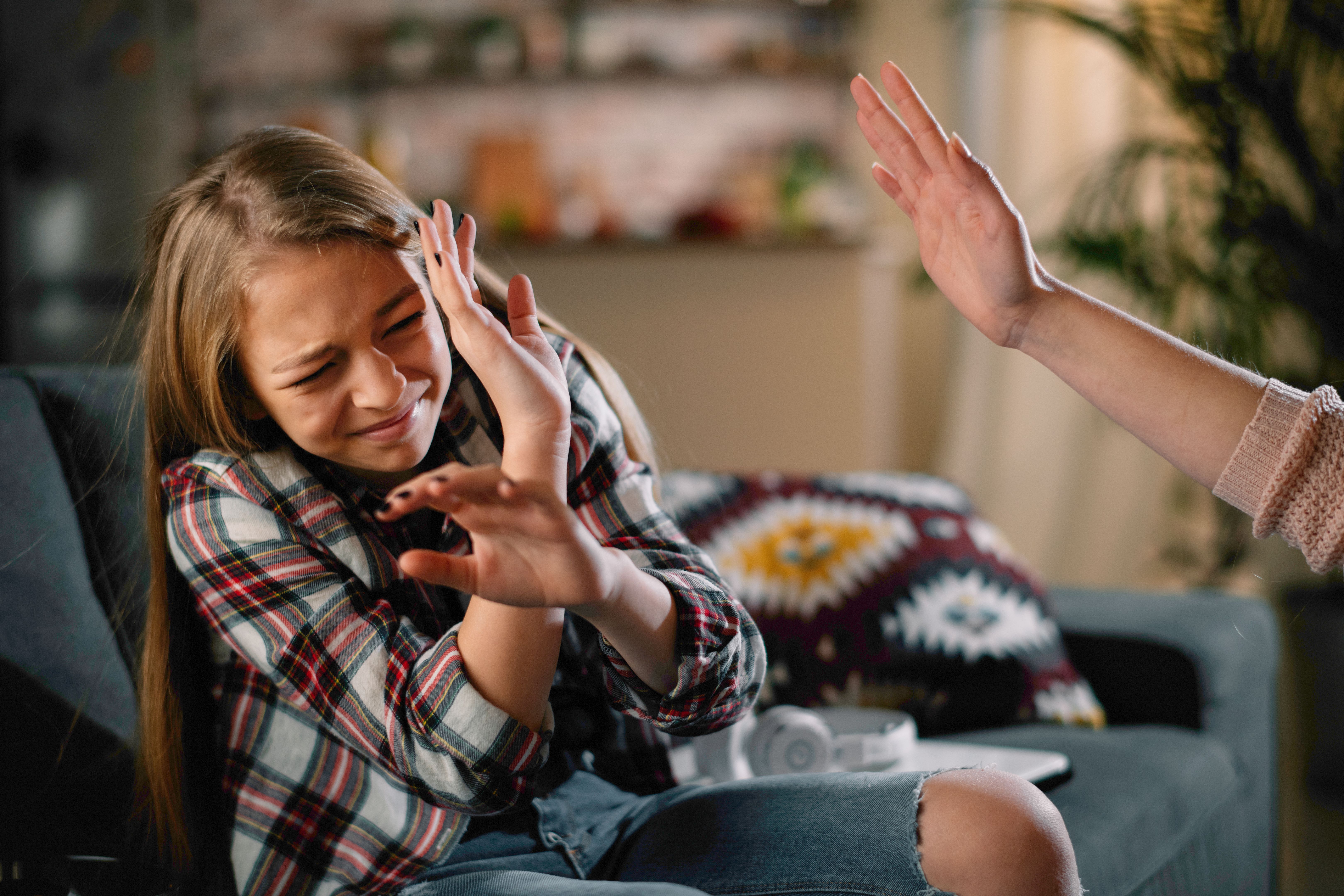 Mother slapping her daughter.